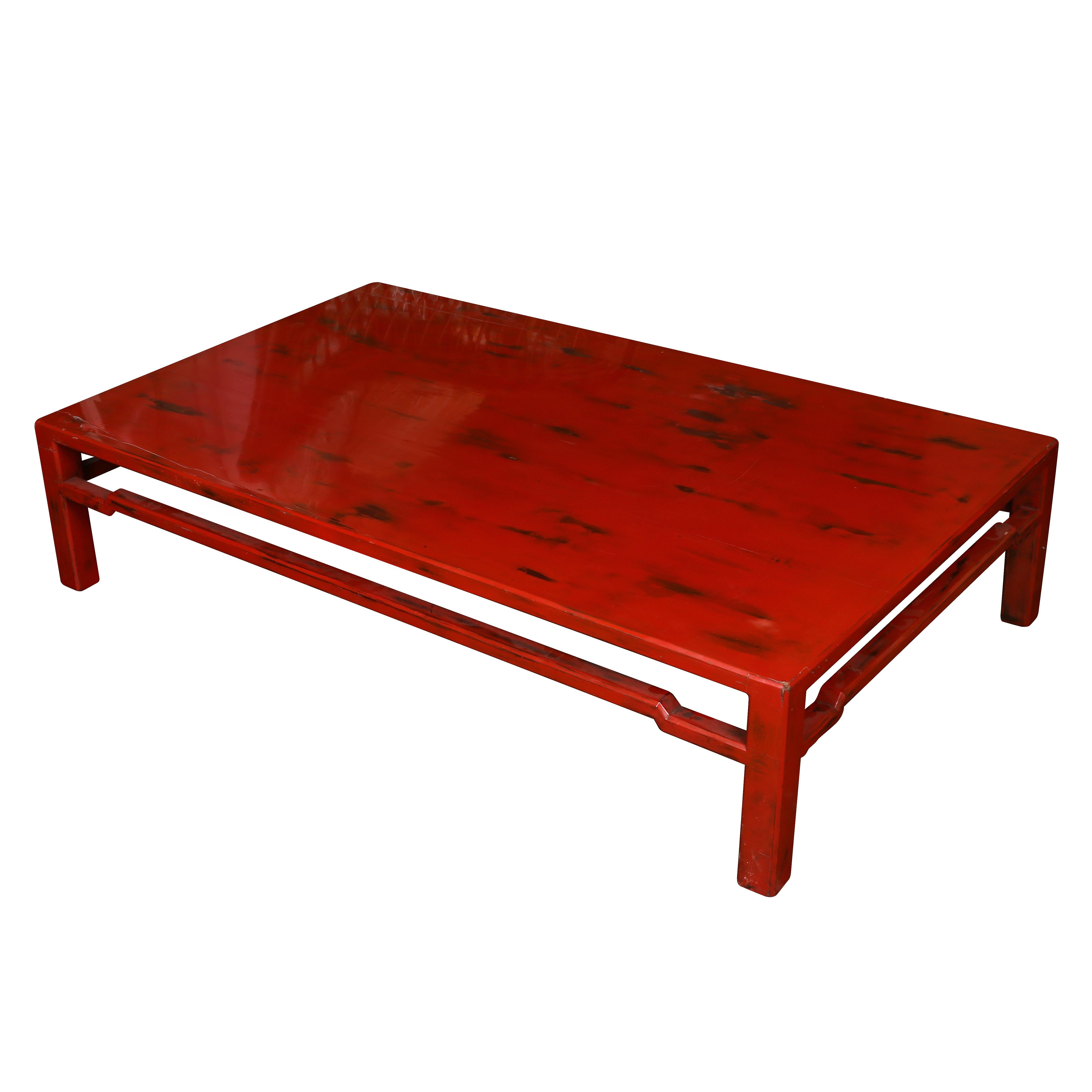 Chinese red lacquer cocktail table rubbed to give a distressed look.