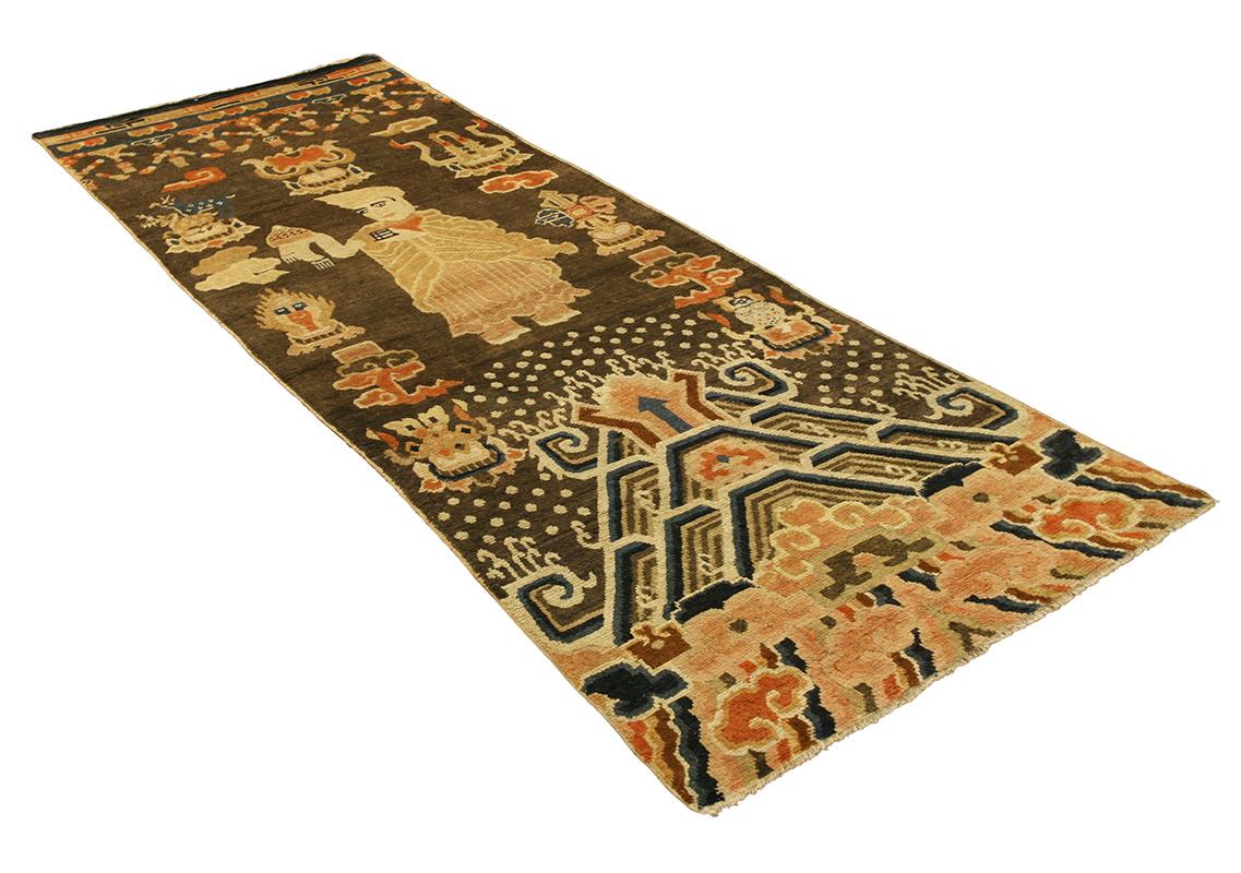This exquisite Chinese Rug Ningxia is a captivating weave of history and artistry, masterfully woven to narrate stories of ancient traditions and spiritual symbolism. The rug's dimensions offer an elongated canvas, showcasing an array of intricate
