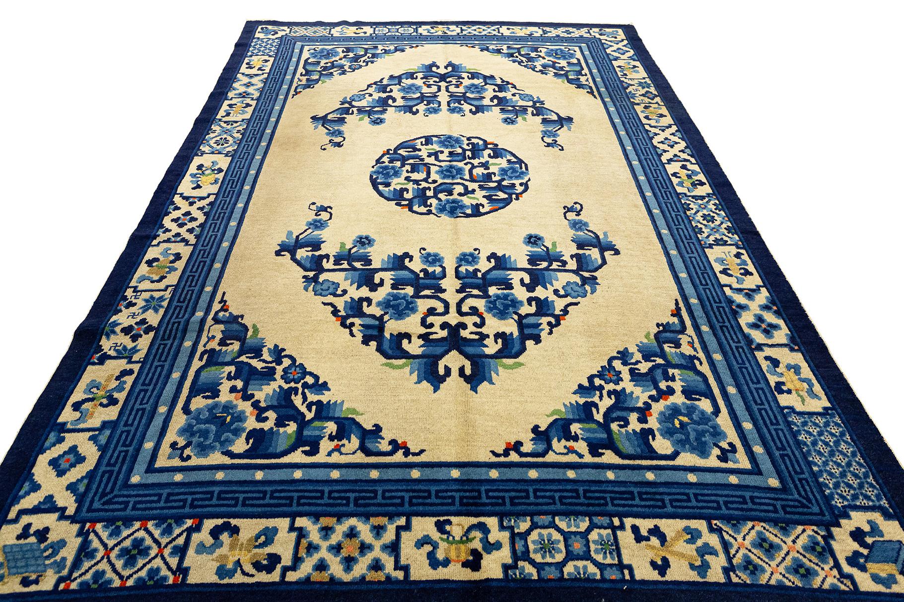 Antique Chinese Peking Rug, 1920 ca. A Chinese carpet with a classic layout with medallion and four corners on an ivory background. The details and nuances are very well defined. The very rich and well-proportioned border carries various elements of
