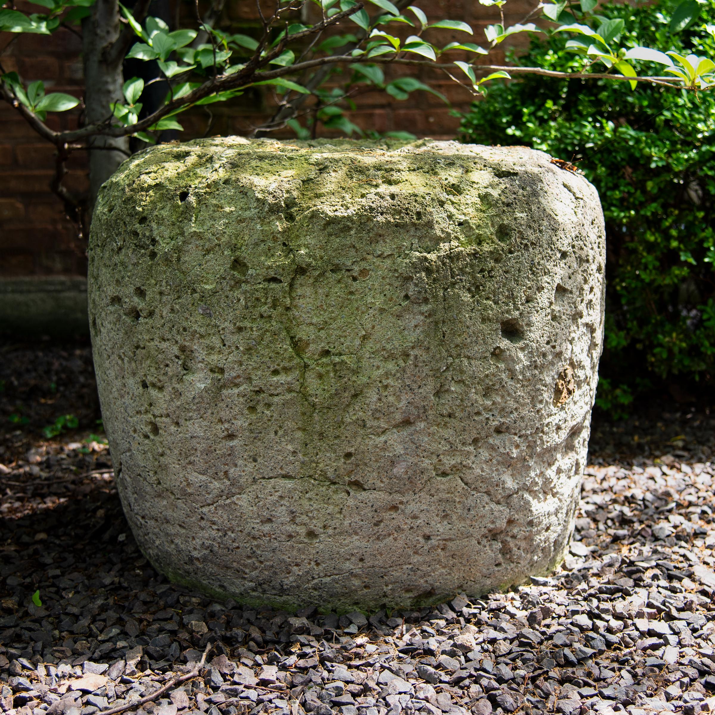 Simply shaped with an elegant form, this large limestone vessel is actually a runner stone, a key component to a traditional Chinese grain mill. Set atop an extensively carved mill stone, the runner stone was harnessed to a donkey or mule that