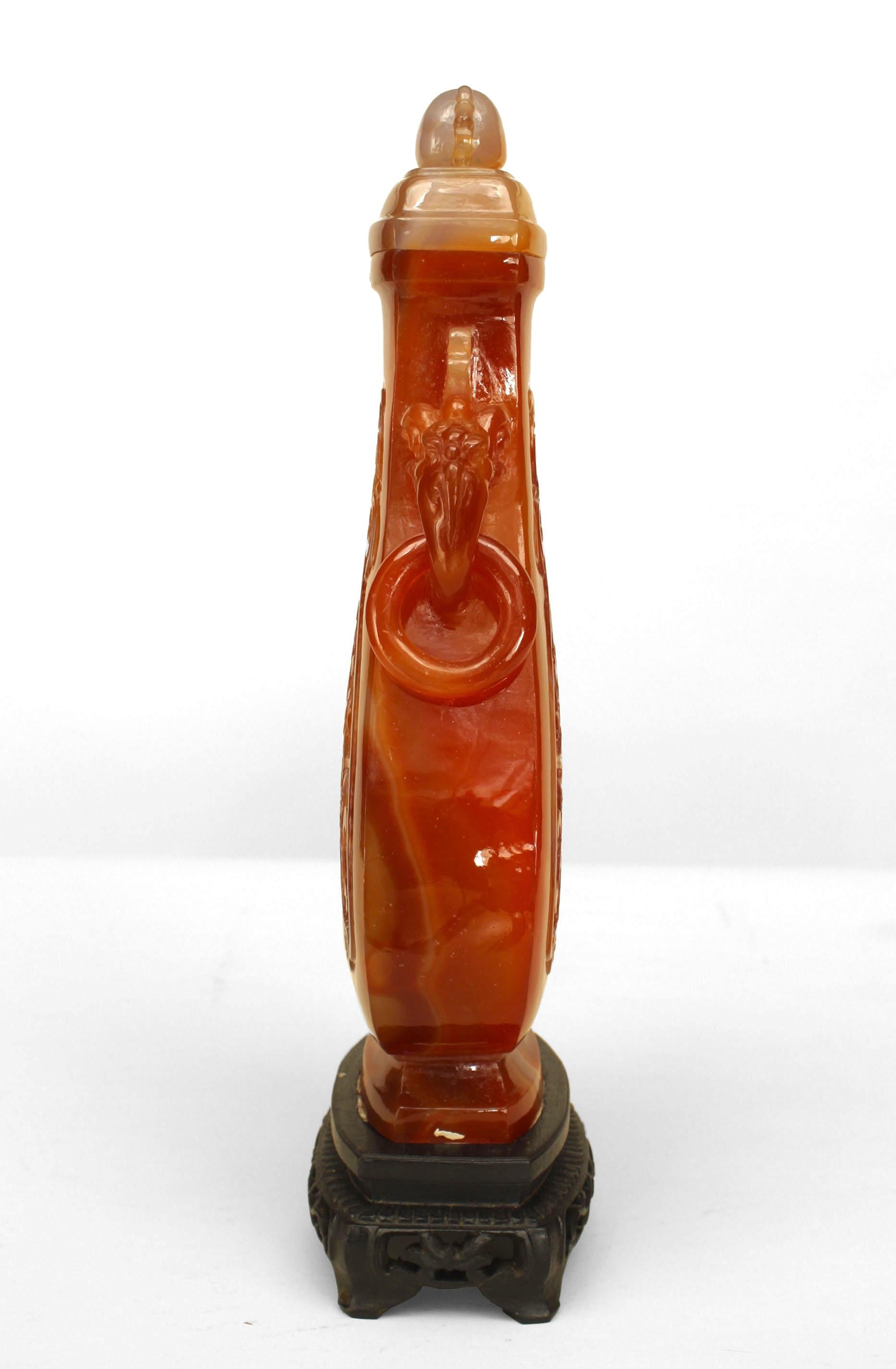 Asian Chinese rust agate tapered urn with carved elephant handles having rings and scroll & floral carving in relief with a finial top with filigree sides. (modern base 1¬O