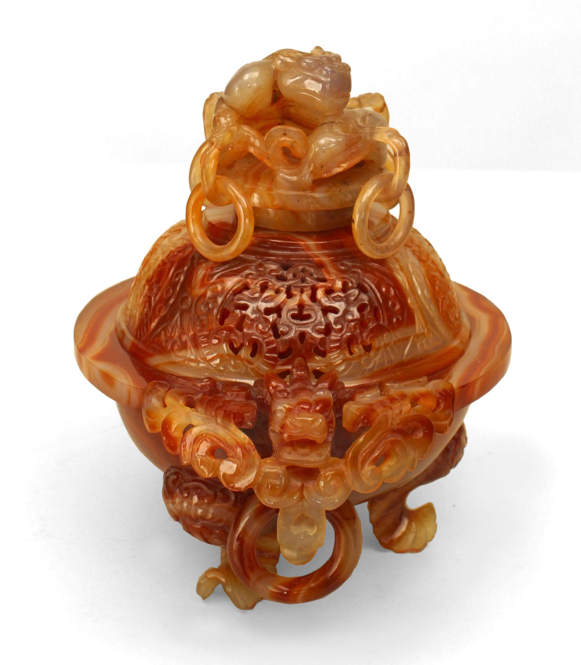 Asian Chinese rust colored agate urn (incense burner) with pierced round cover with rings and carved monkey and dragon handles resting on a base of 4 fish. (modern base 1¬O