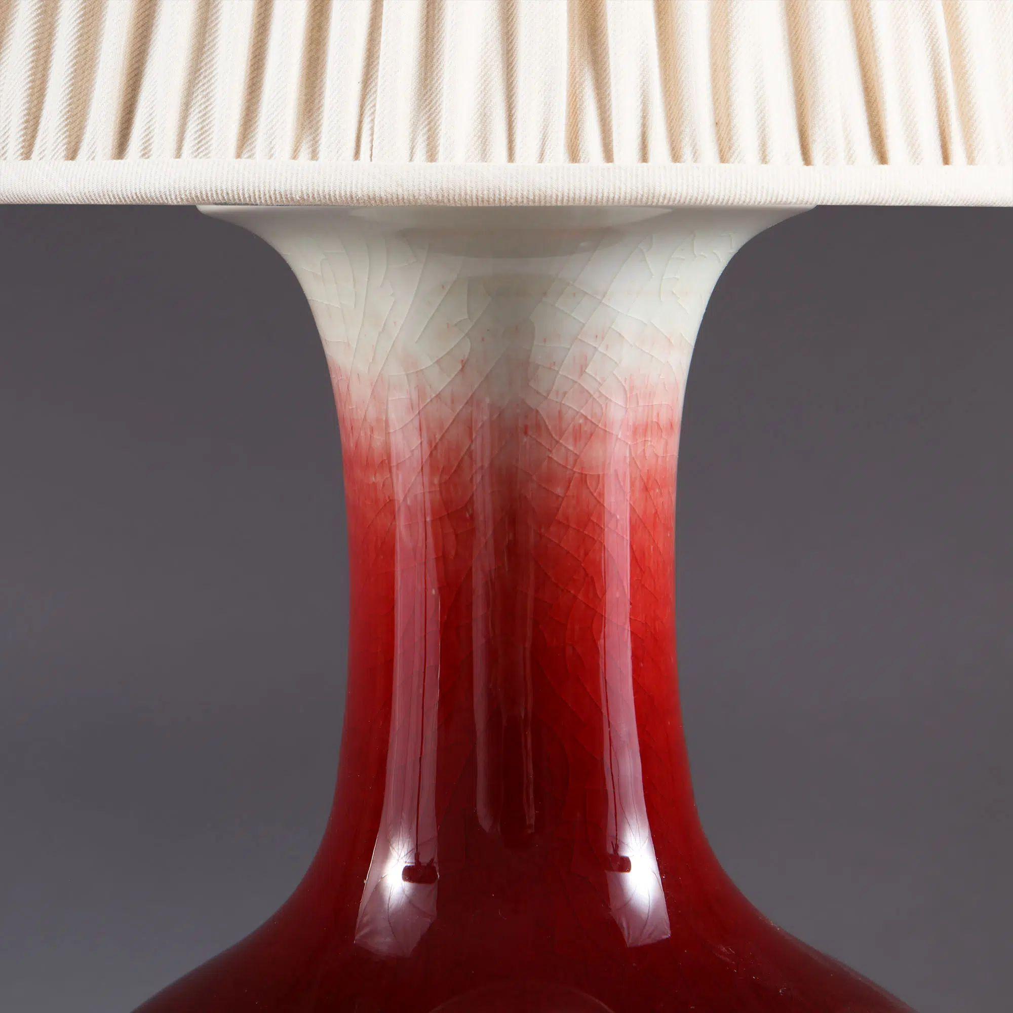 Chinese Sang de Boeuf Vase mounted as a table lamp.

An attractive Chinese sang de boeuf vase with a flared rim, the neck gradually transforming from clear glaze to rich blood red, the base with flicks of blue and purple. Now mounted as a table