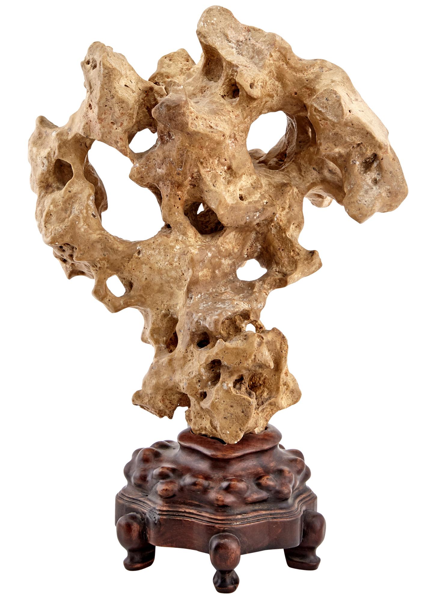 A Taihu scholar rock in a mushroom form balanced on a custom wood stand, purportedly purchased from Kemin Hu, the well known collector, educator and author on this particular subject. The stone display a well weather-smoothed surface in a lovely
