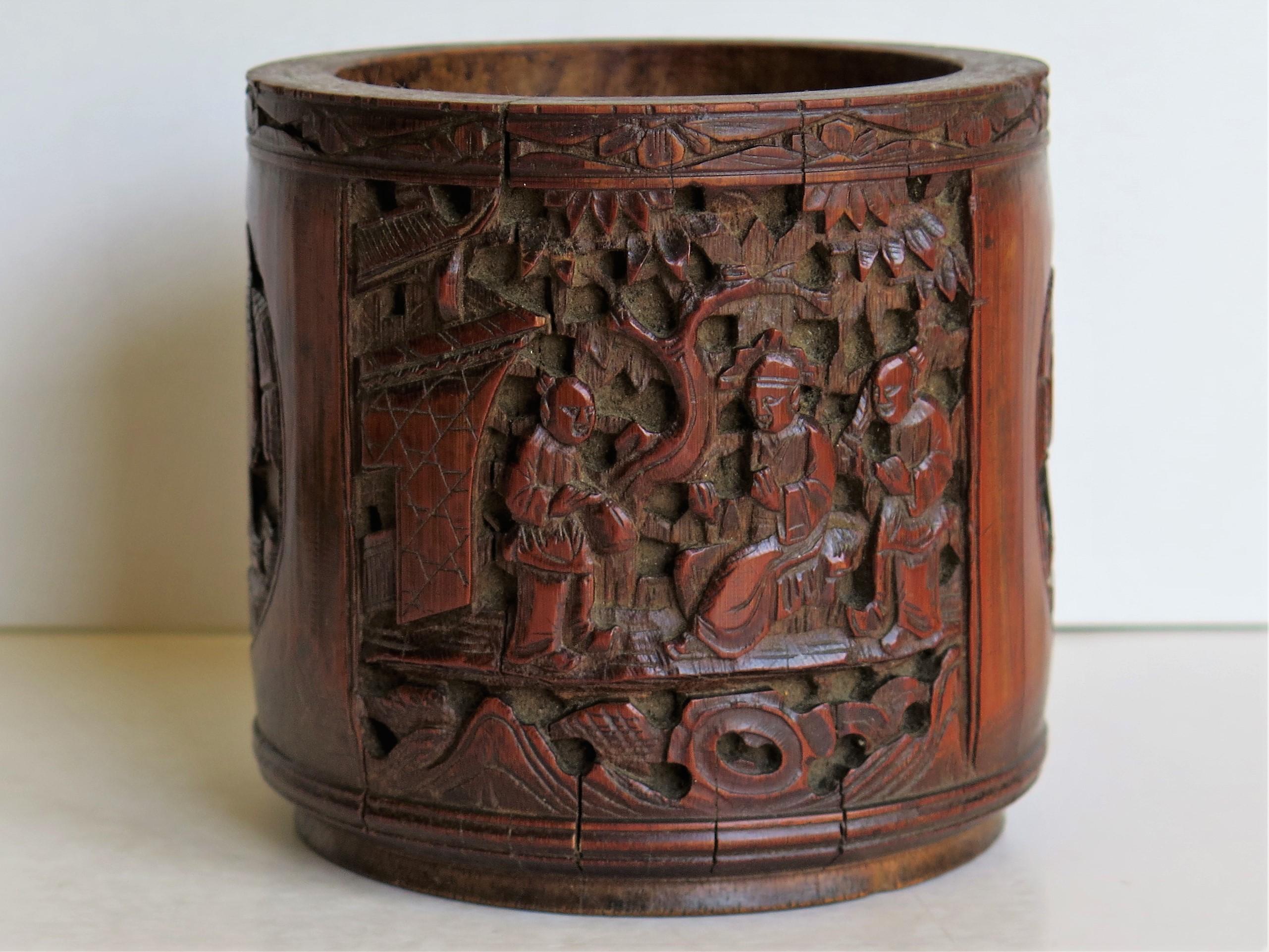 This is a finely hand-carved Chinese bamboo scholars Brush Pot or bitong which we date to the early 19th century of the Qing dynasty, circa 1830, but could be earlier.

The bamboo has been intricately hand-carved in four different alternating
