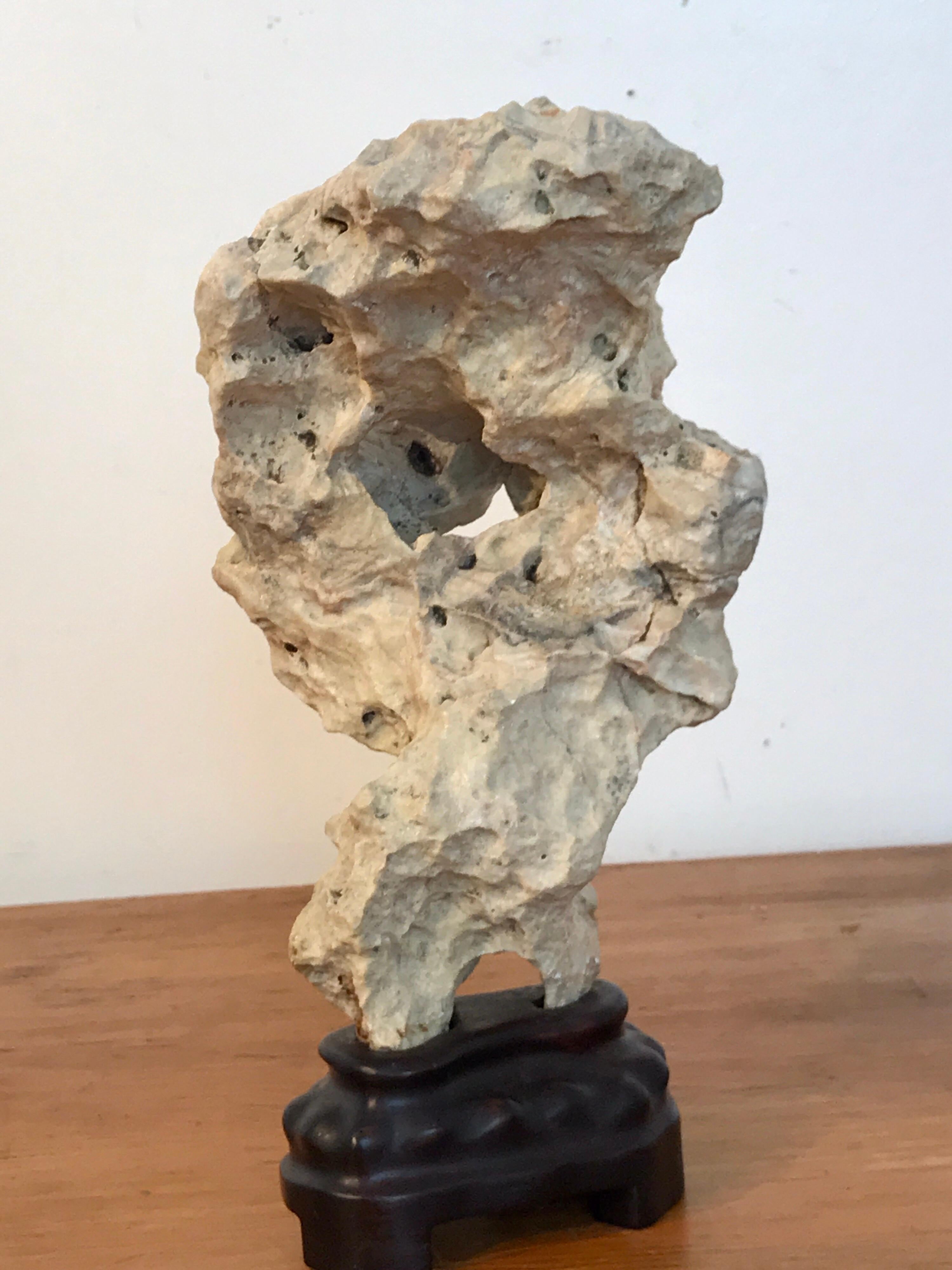 Chinese Scholar's Rock, of Taihu Stone, beautiful specimen limestone, in a custom carved hardwood stand.
Stand alone measures 4