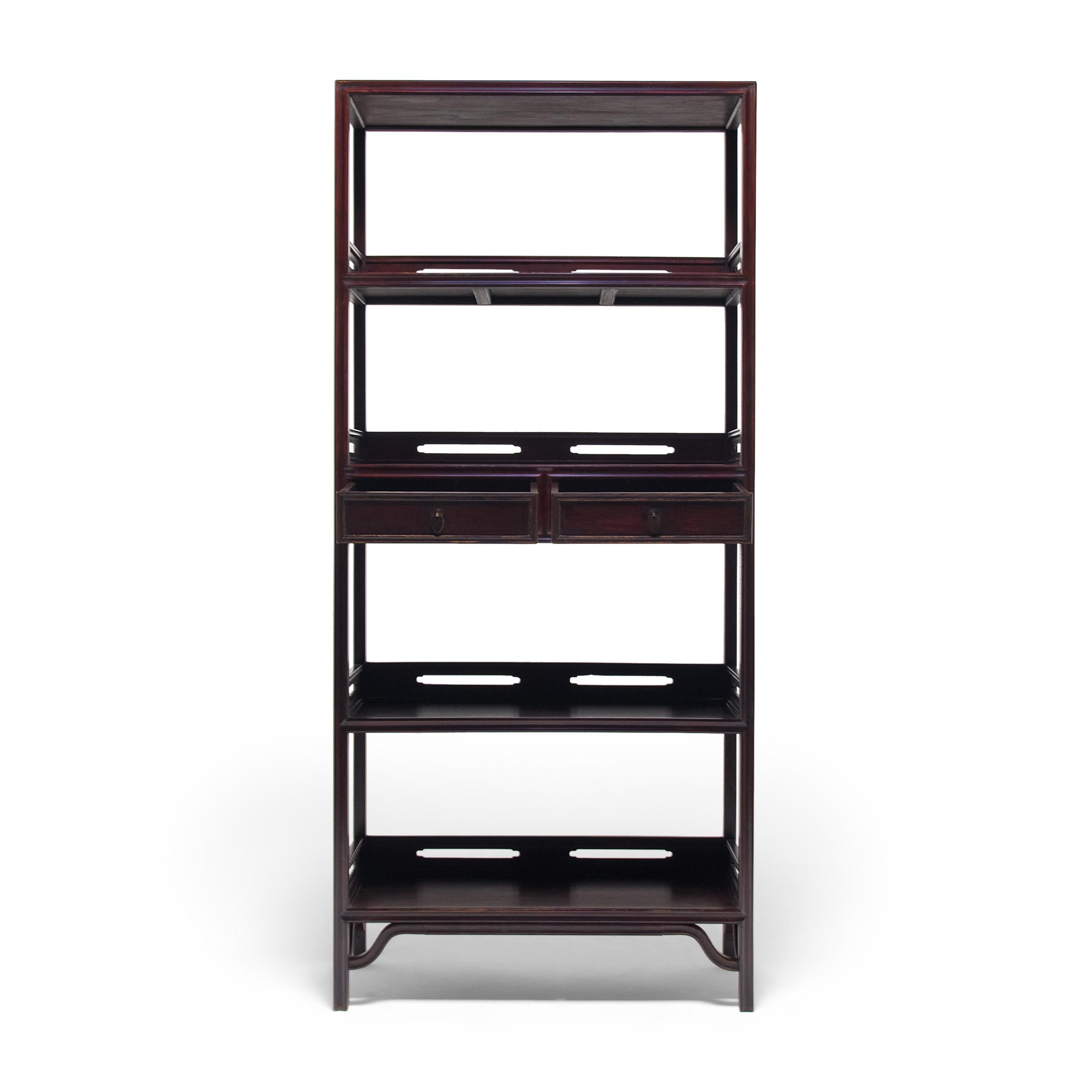 This early 20th century bookcase once stood in a Qing-dynasty scholars' studio, piled high with books and painted scrolls. Considered a status symbol, books were given pride of place on impressive shelves such as this, alongside precious objects and