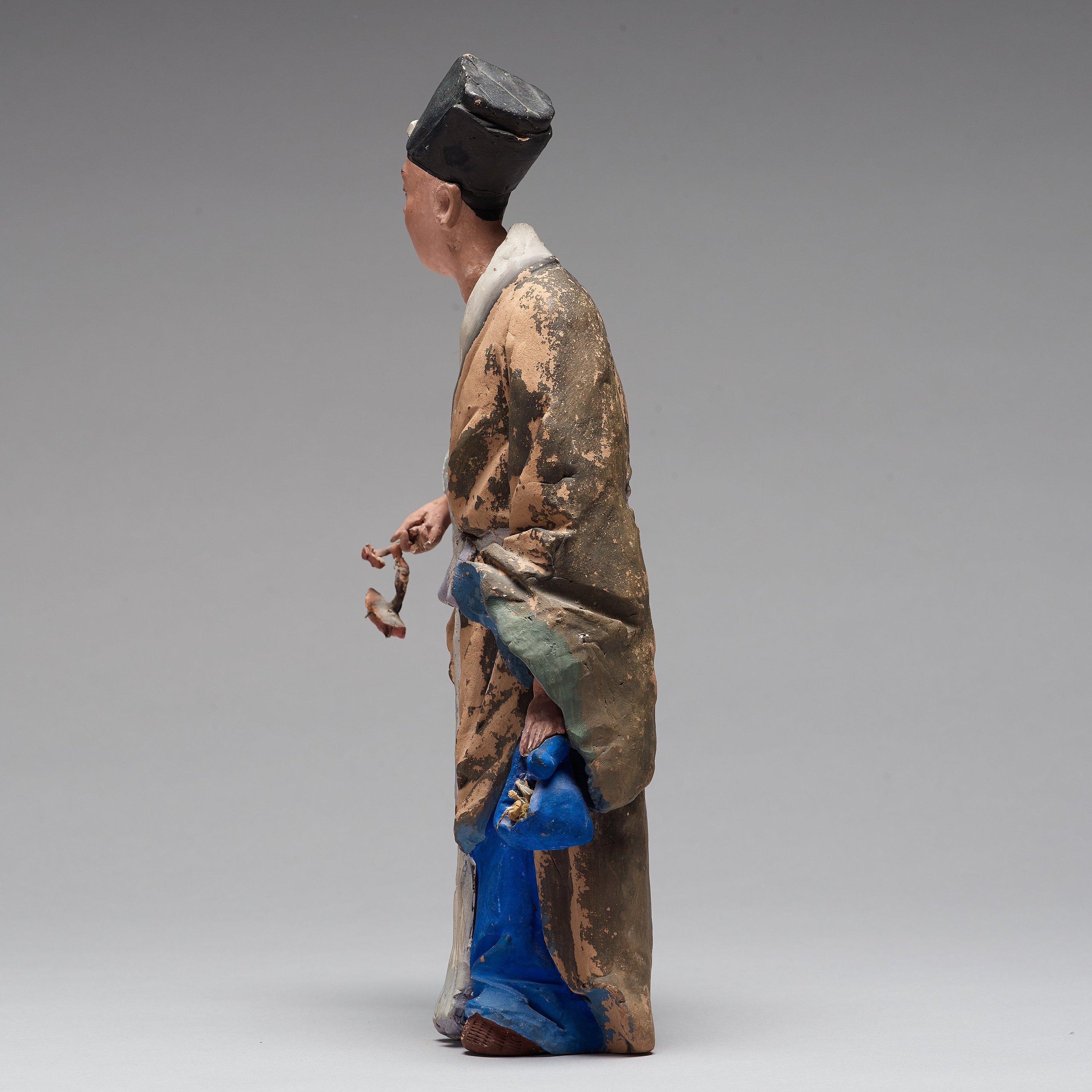20th Century Chinese Sculptured and Painted Clay Figure of a Man Holding a Lingzhi Mushroom