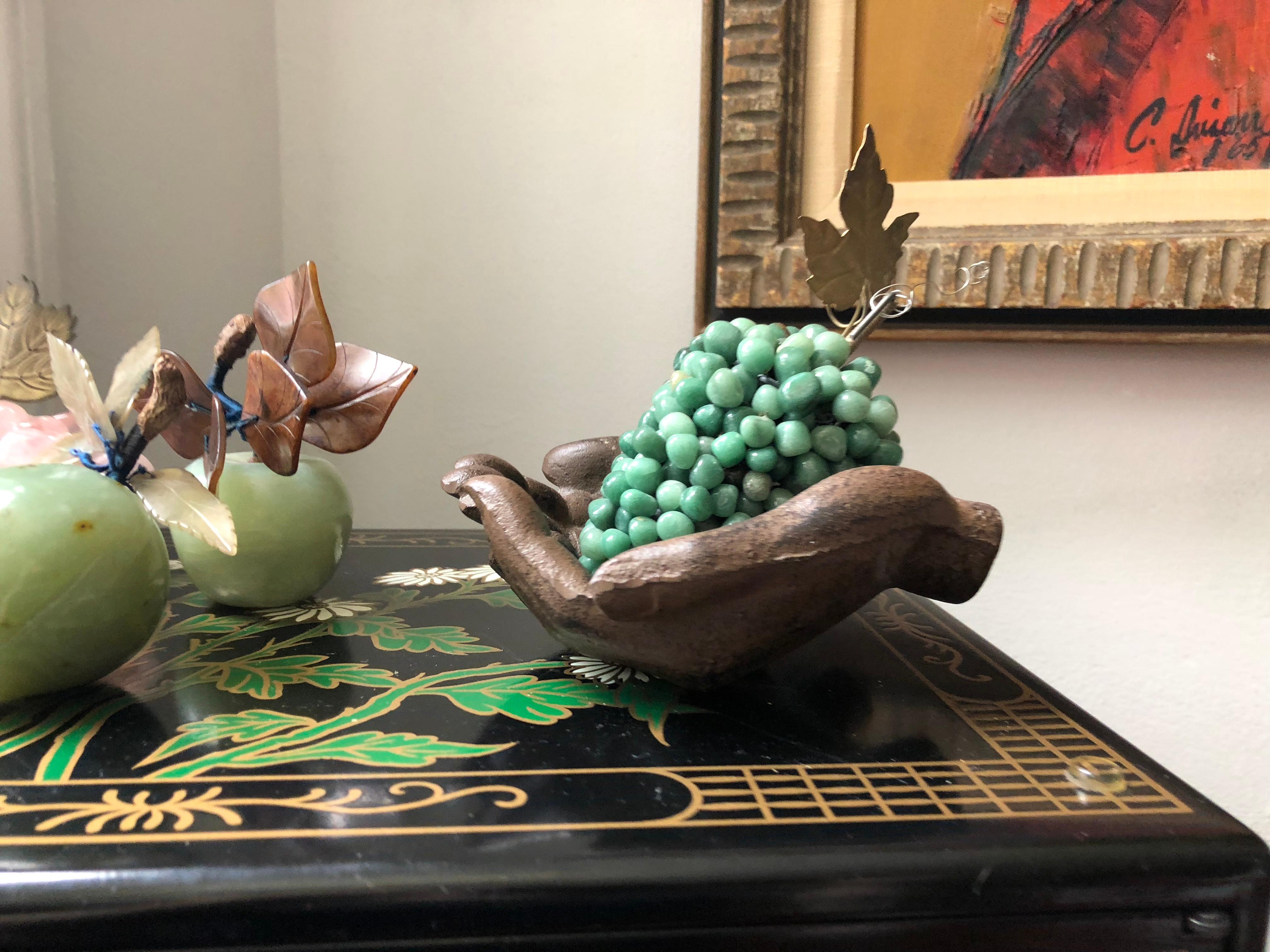 Gorgeous set of semi-precious hard-stone fruit sculptures, includes 2 bowenite apples with serpentine leaves, an aventurine bunch of champagne grapes, and 2 bunches of rose quartz grapes, includes one mid century iron sculpture.
