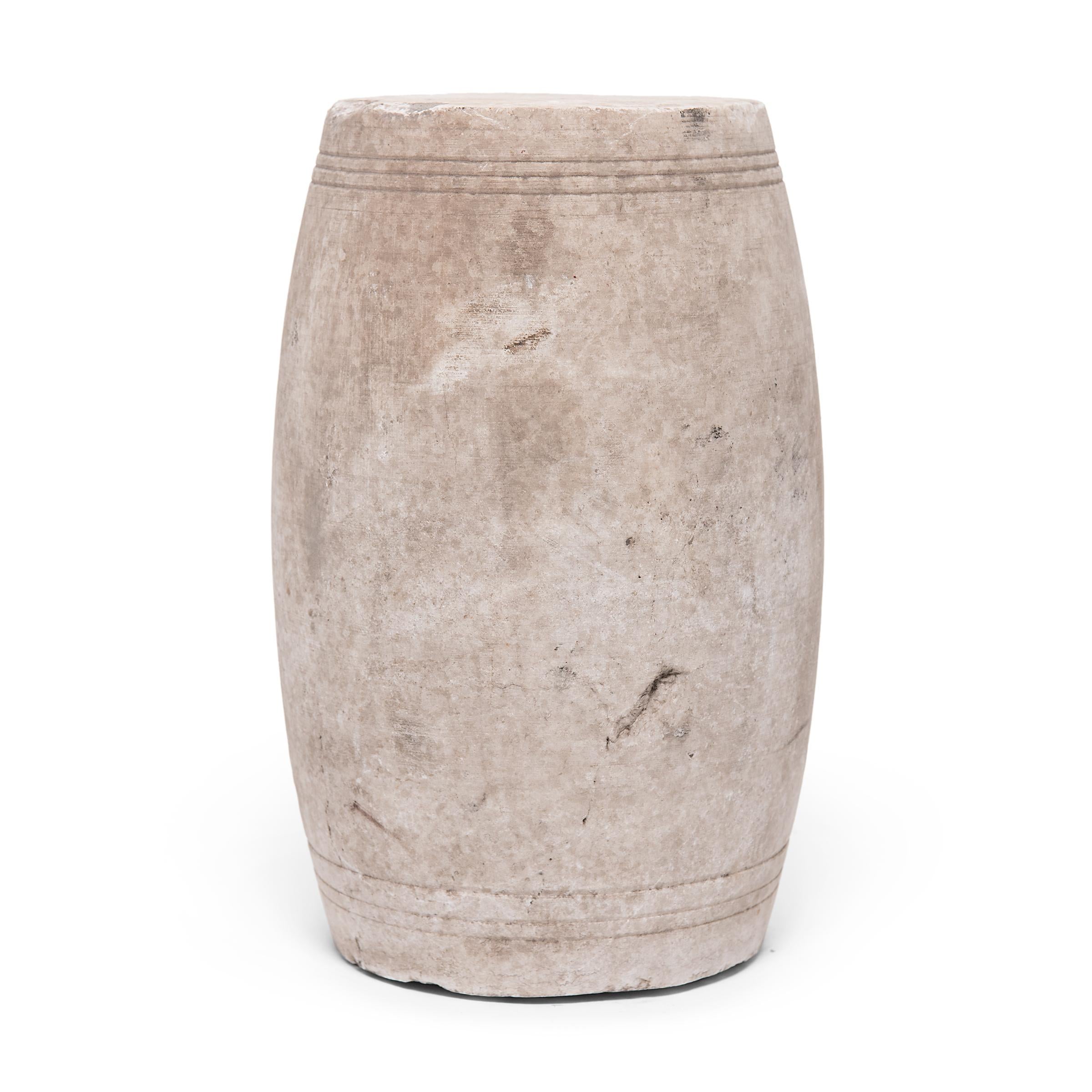 This minimalist drum stool was carefully carved from a single block of marble by artisans in China's Shanxi province. Drum-form stools such as this were traditionally used in gardens and outdoor pavilions where upper class scholars read, wrote,
