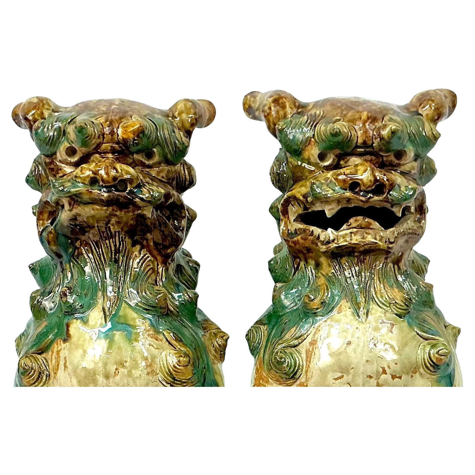 Pair of Early 20th Century Chinese Shisa Polychromed Glazed Foo Dogs, also known as Fu dogs. Statues are traditional Chinese guardians, representing protection, wealth, and good fortune in Chinese cultures.  This ceramic pair is painted and glazed