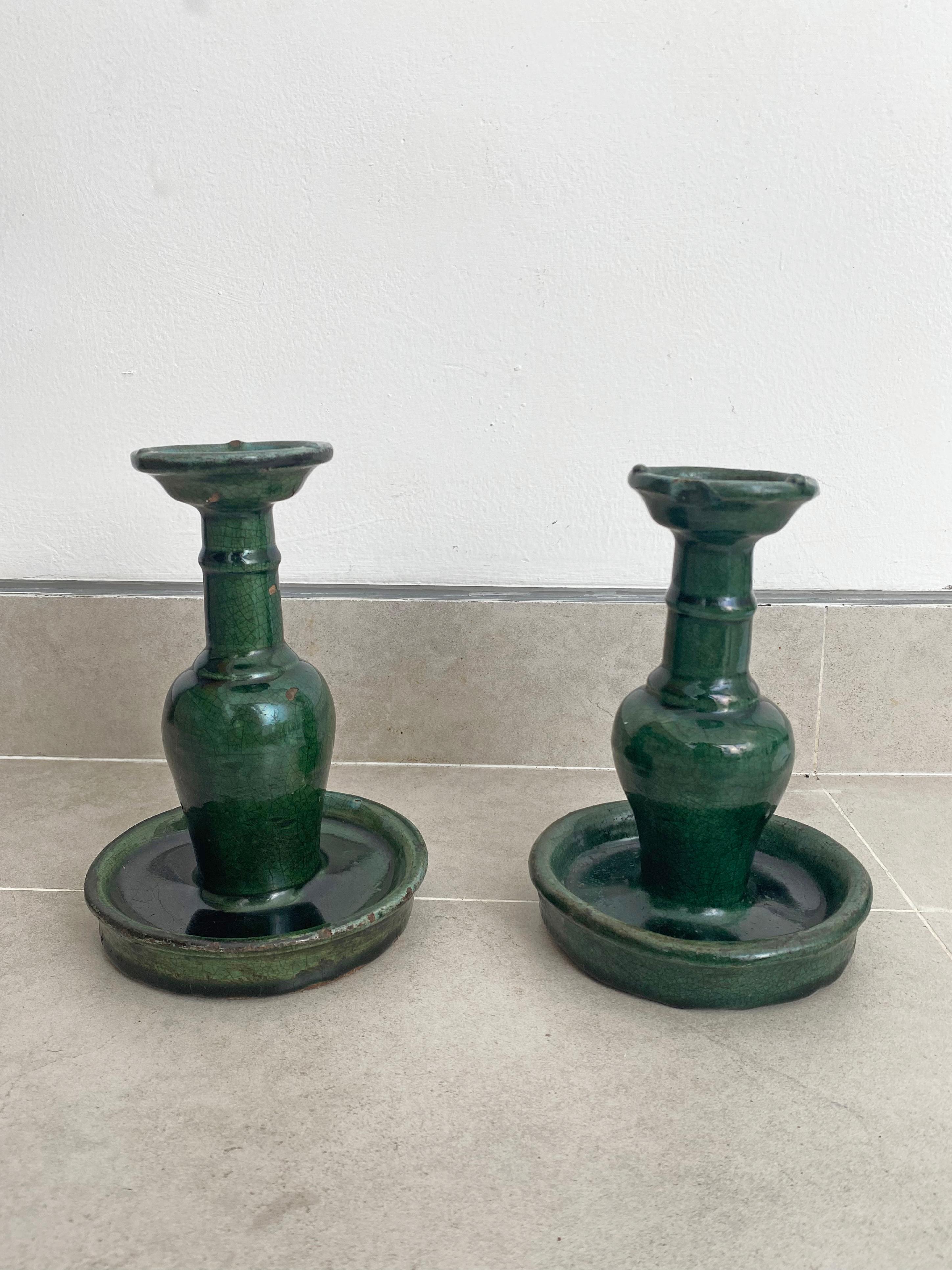 This set of Shiwan ware oil lamps from the early 20th century features the distinctive green glaze. Shiwan ware is a style of Chinese pottery from the Shiwanzhen district near Guangdong, China. With a stunning green finish they would make for unique