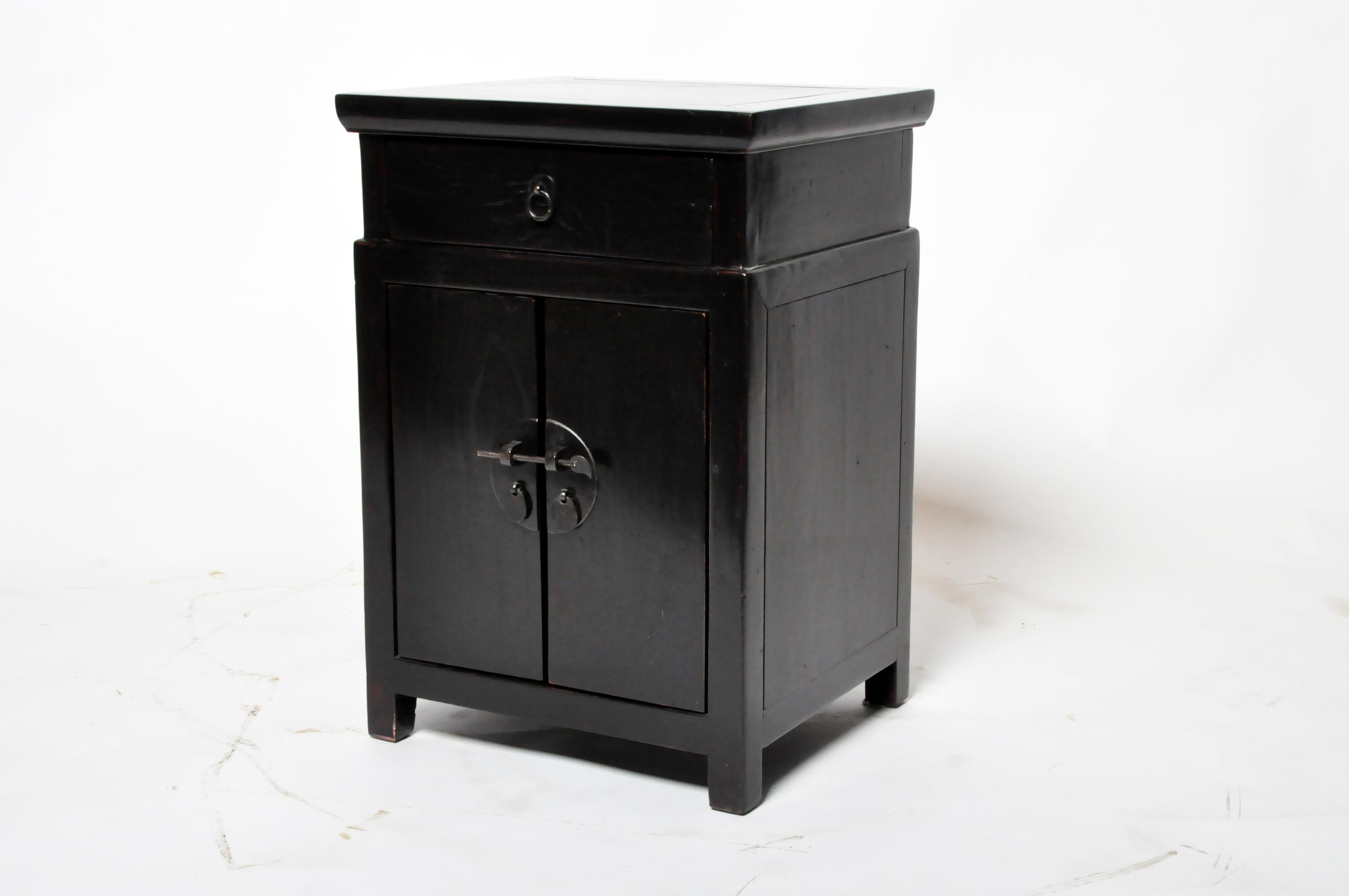 This side chest was originally part of a set. It has been completely restored and refinished in black lacquer and French polish. It features traditional nail-less joinery and new brass hardware. 
 