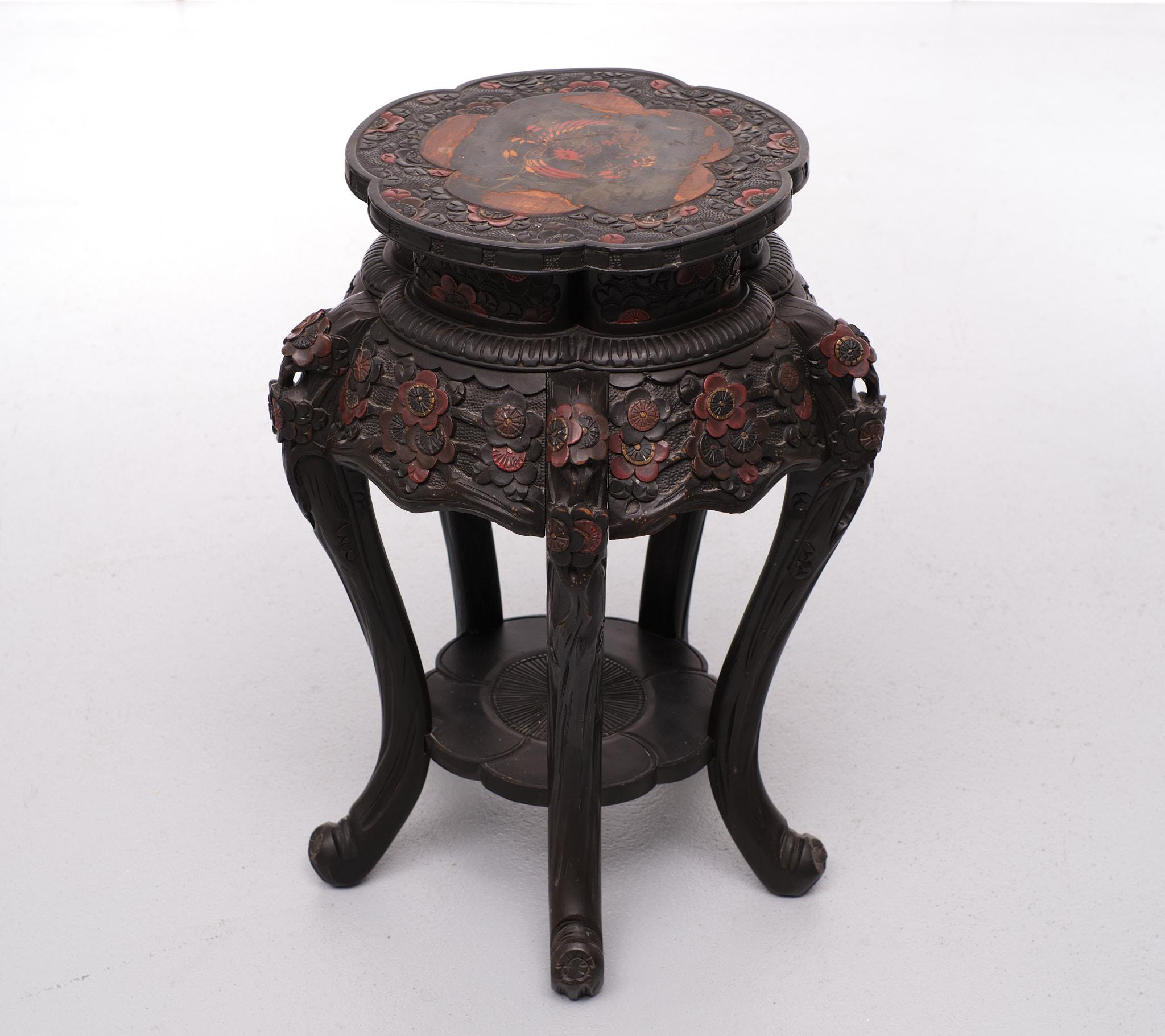 Very nice Chinese side table. Black base hand carved
with colored flowers. On top a painted bird, some wear on the top of the table. 
Probably bin damaged by a flower pot.