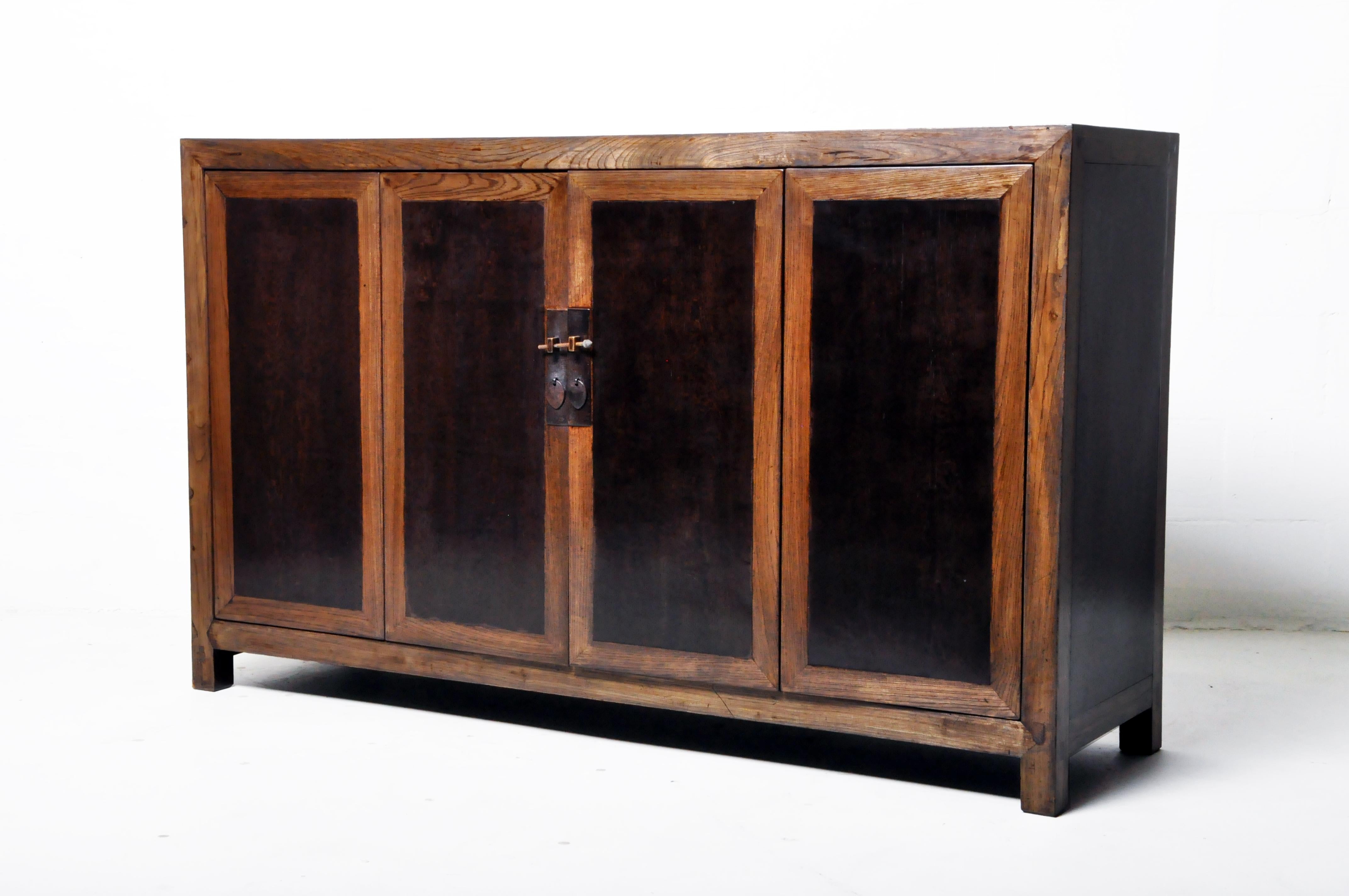 This Chinese sideboard was made from elmwood and pinewood with traditional nail-less joinery. The piece features a pair of bi-fold doors and a shelf for storage. Wear consistent with age and use.
 