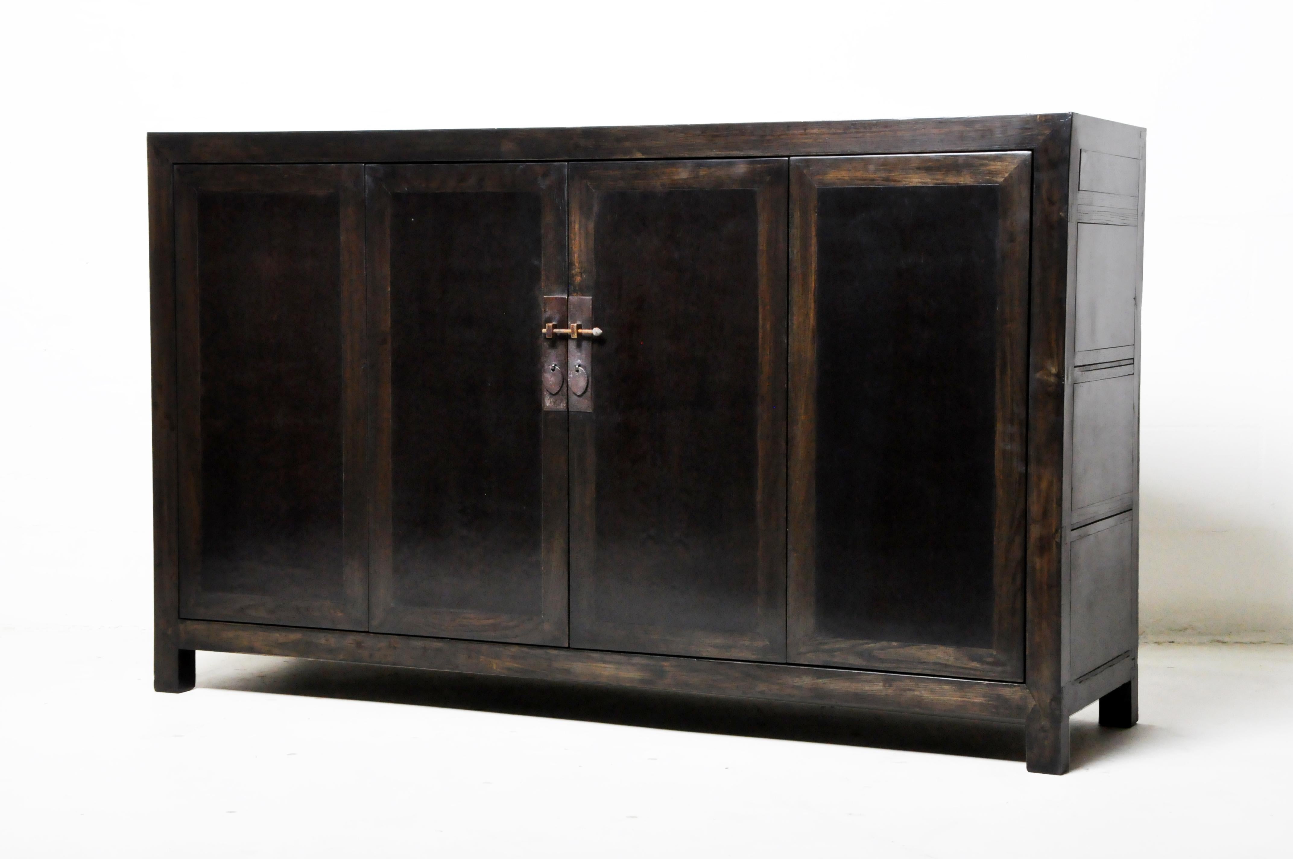 This Chinese sideboard was made from elmwood and pinewood with traditional nail-less joinery. The piece features a pair of bi-fold doors and a shelf for storage. Wear consistent with age and use.
  
