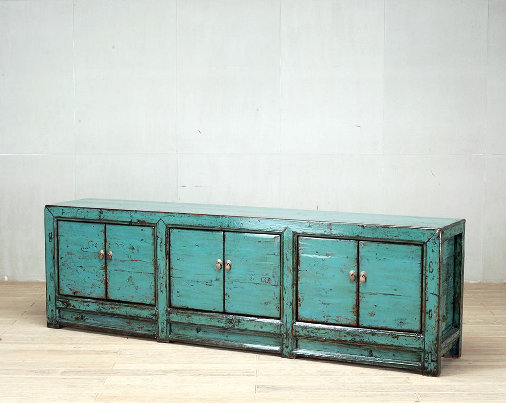 This low cabinet was made from reclaimed pine wood with traditional nail-less joinery. The piece was painted a turquoise color and has been enhanced with a sophisticated French polish finish. The piece was restored in a workshop using reclaimed wood