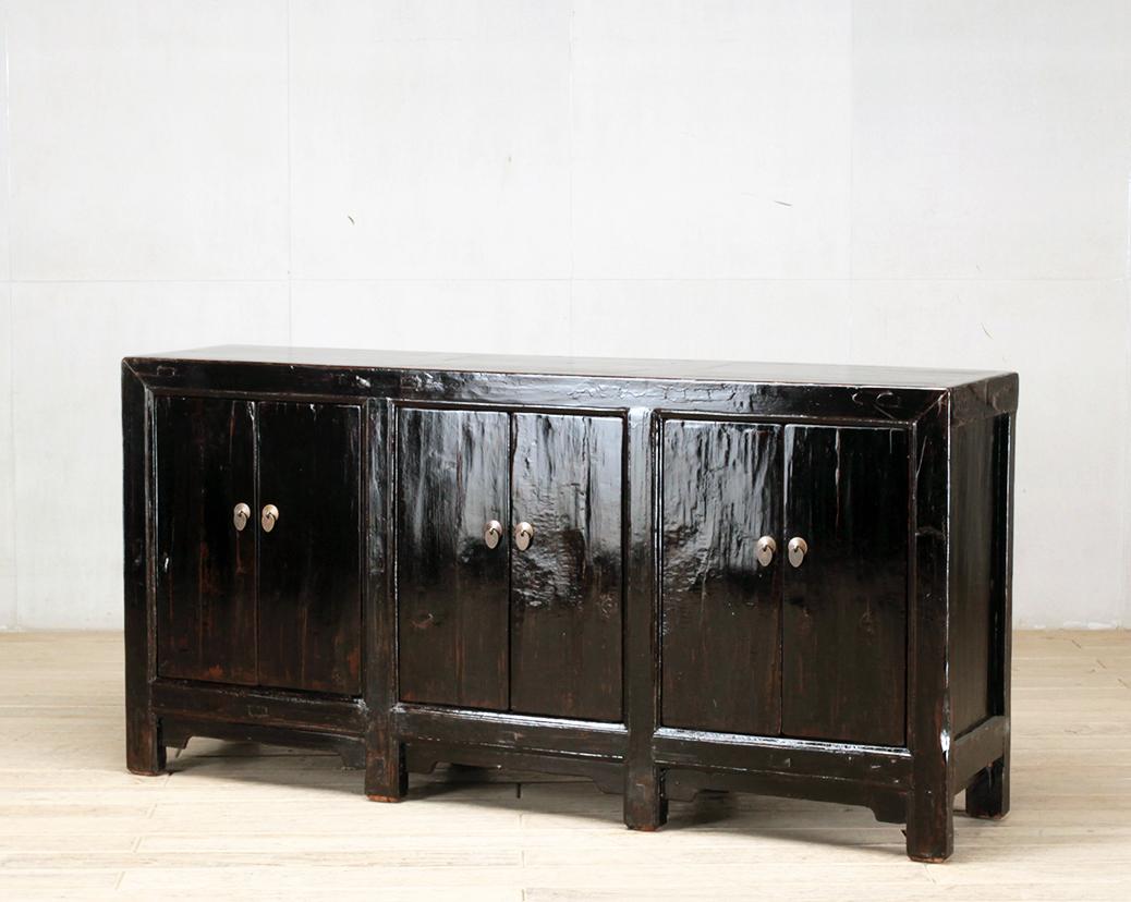This sideboard was made from reclaimed pine wood with traditional nail-less joinery. The pine wood has been enhanced with a sophisticated French polish finish. The piece was restored in a workshop using reclaimed wood in China and features six doors