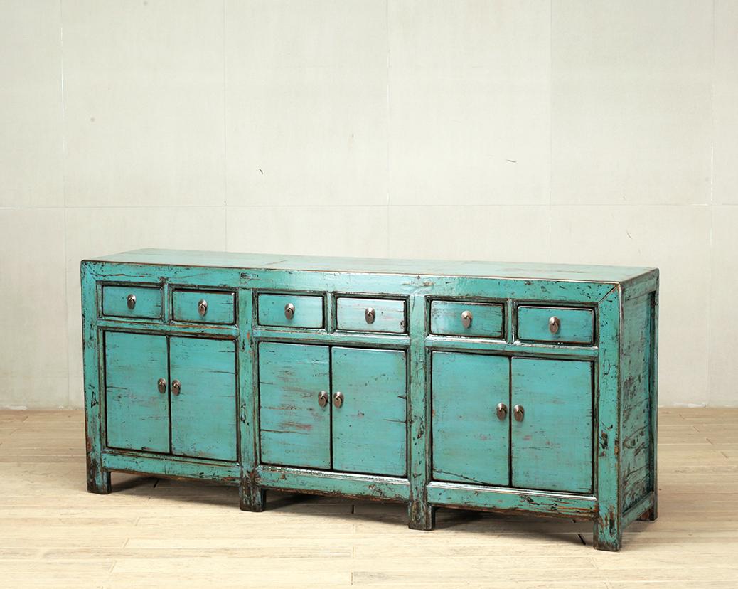 This sideboard was made from reclaimed pine wood with traditional nail-less joinery. The turquoise color on the piece has been enhanced with a sophisticated French polish finish. The piece was restored in a workshop using reclaimed wood in China and