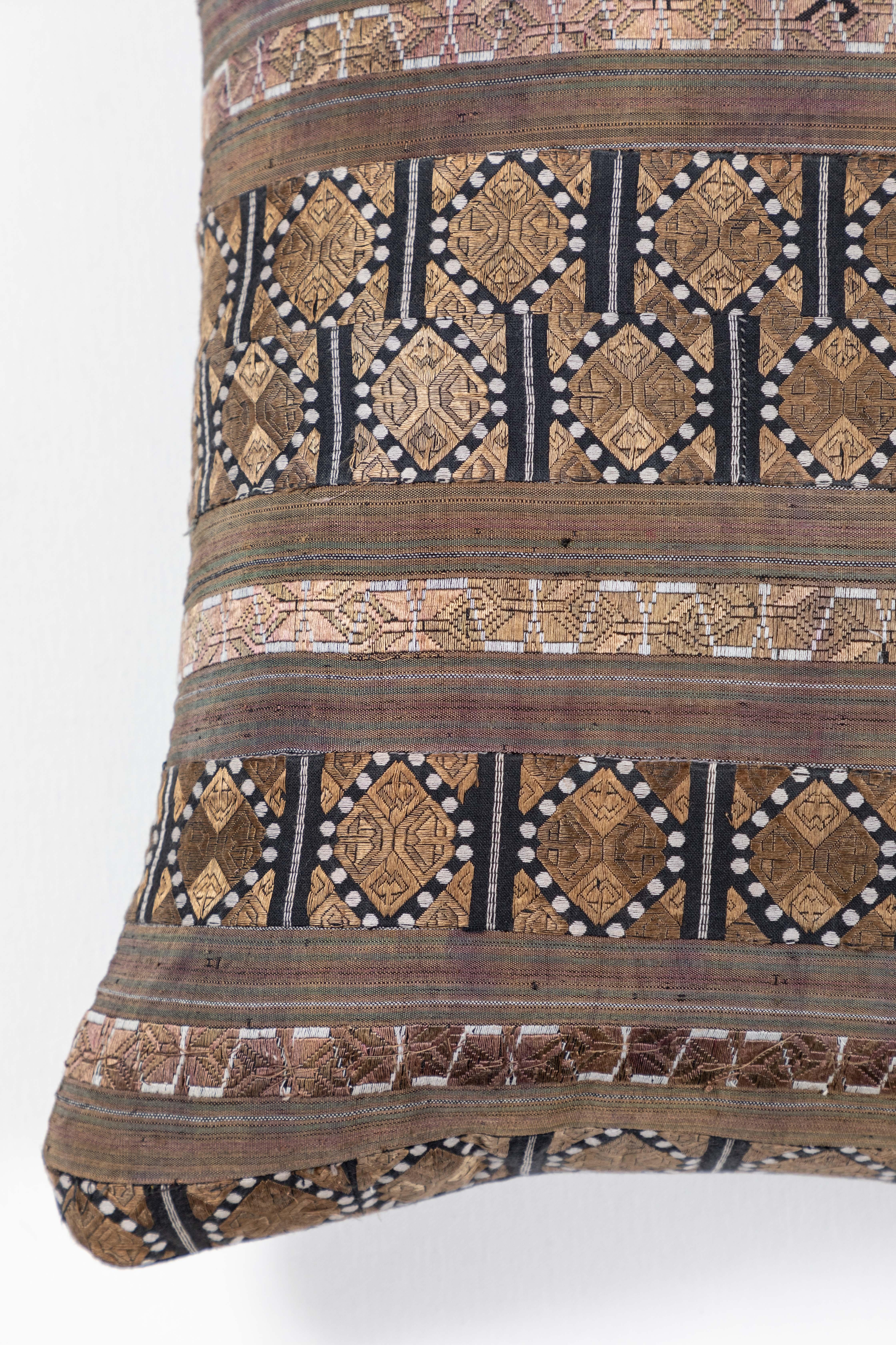 Hand loomed and brocaded silk. Chinese Hill Tribe production. Skirt trim ribbons sewn together. Black linen back, invisible zipper closure, feather and down fill.

 