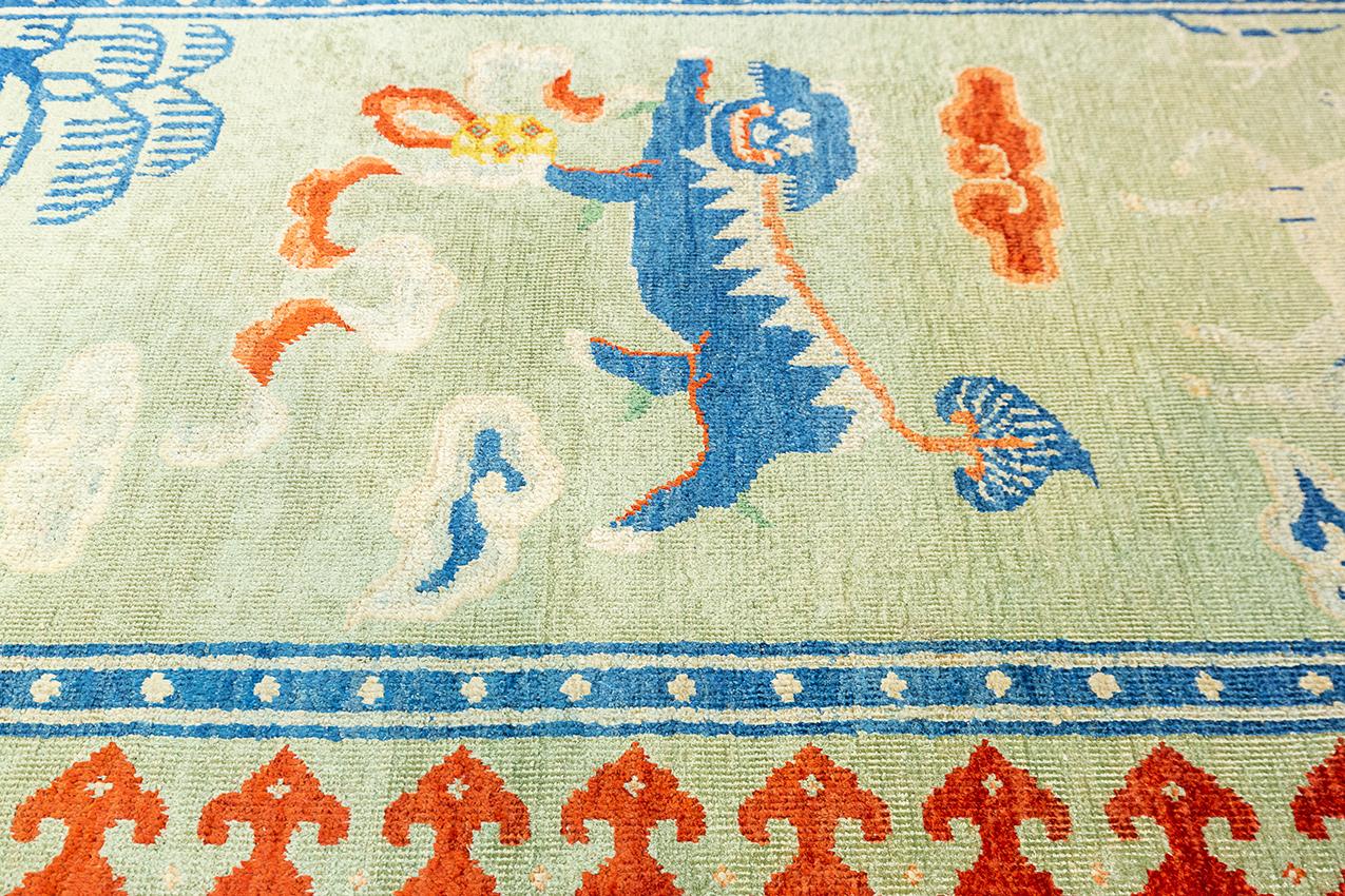 Knotted in silk over cotton warp and weft, this Antique Chinese rug measure 180 x 95 cm. Seemingly simple, the decoration of this rug is instead full of meaning. The sacred mountain, the horse, the big pine tree, the Buddha dog, the deer, and the