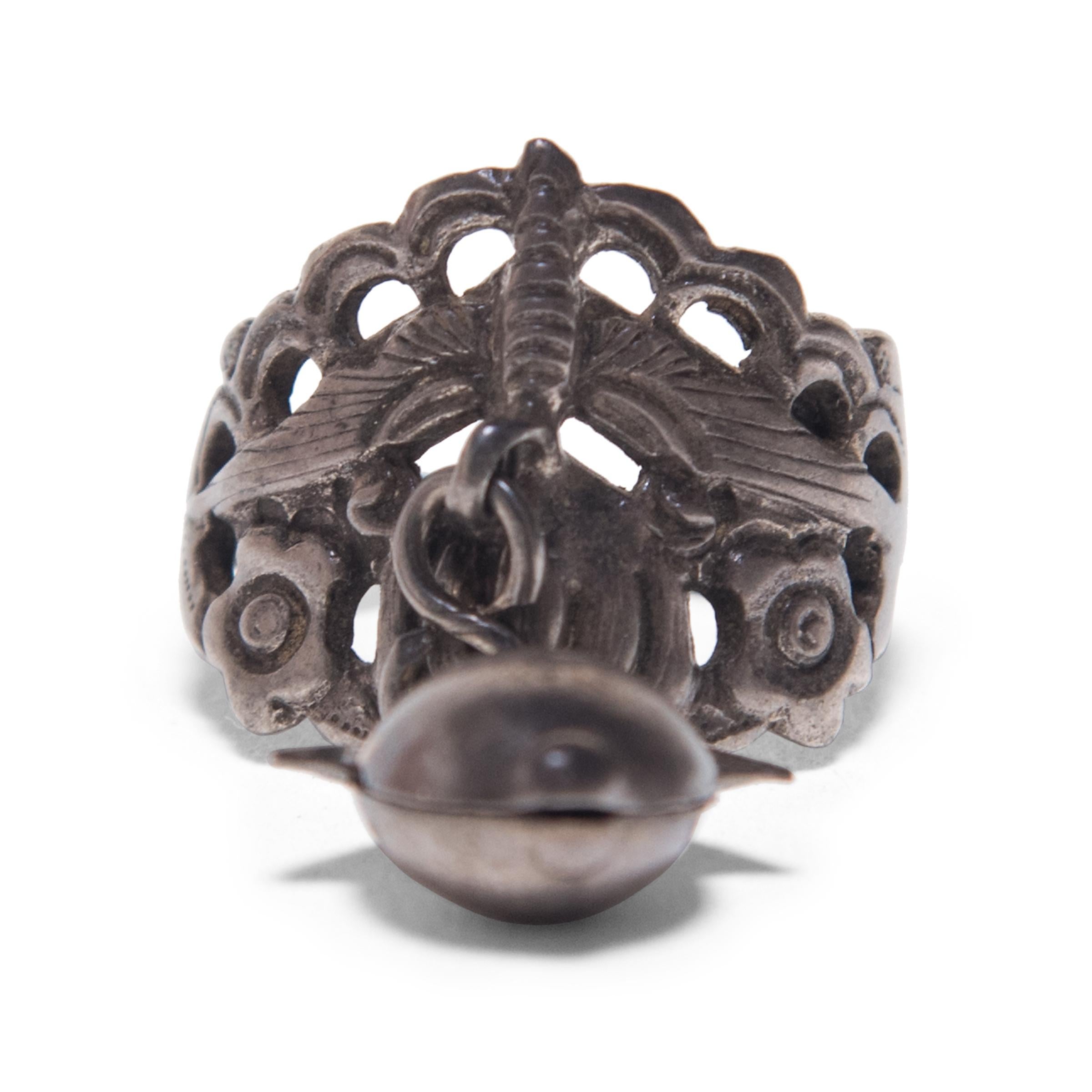 Dated to the late 19th century, this silver charm ring was believed to protect the wearer from bad luck and malevolent spirits. Intricately patterned and laden with symbolism, the ring imparts an everyday blessing. A round, ribbed gourd on one side