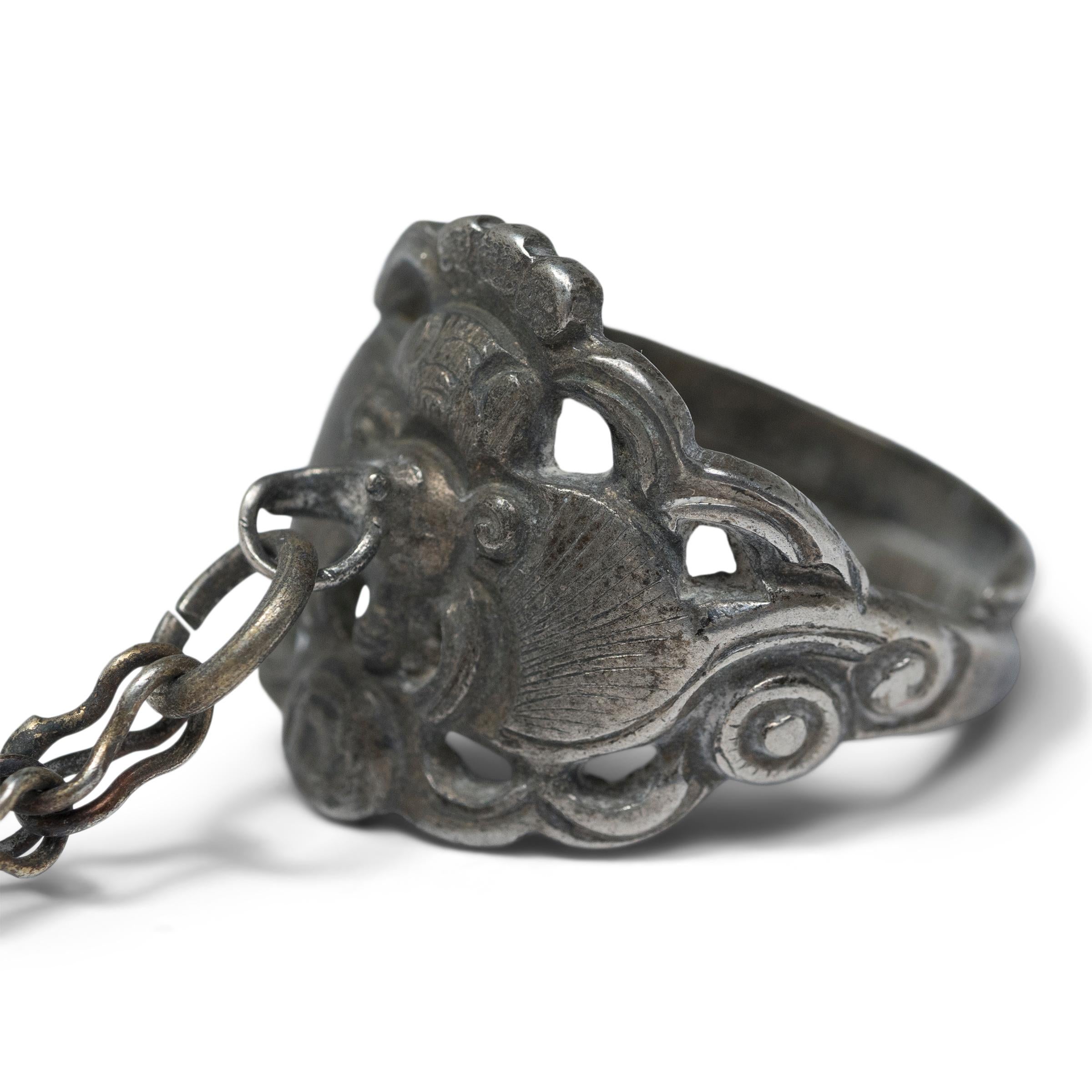 Dated to the late 19th century, this silver charm ring was believed to protect the wearer from bad luck and malevolent spirits. The ring is decorated in open relief with a large bat surrounded by swirling clouds. A visual metaphor for the word