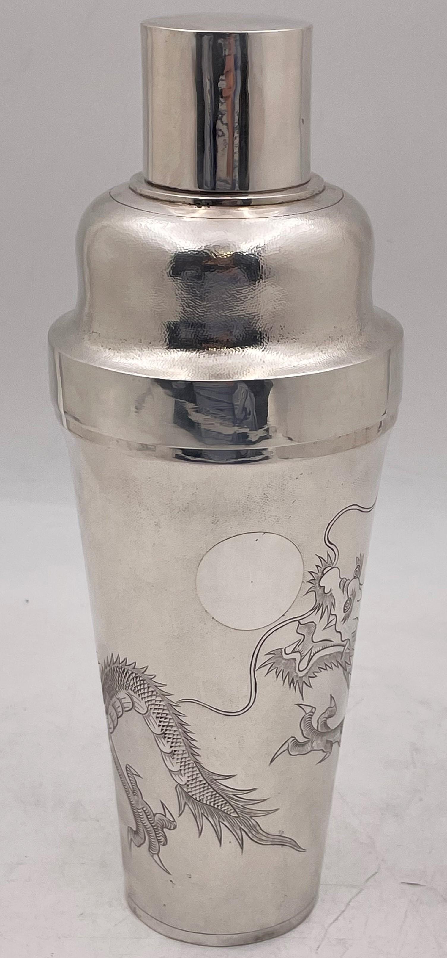 Chinese export, 0.950 silver (higher purity than sterling) cocktail shaker by C. J. & Co from the early 20th century, with engraved dragon motifs on a textured background. It measures 10 1/2'' in height by 4 1/3'' in diameter, weighs 16.8 troy