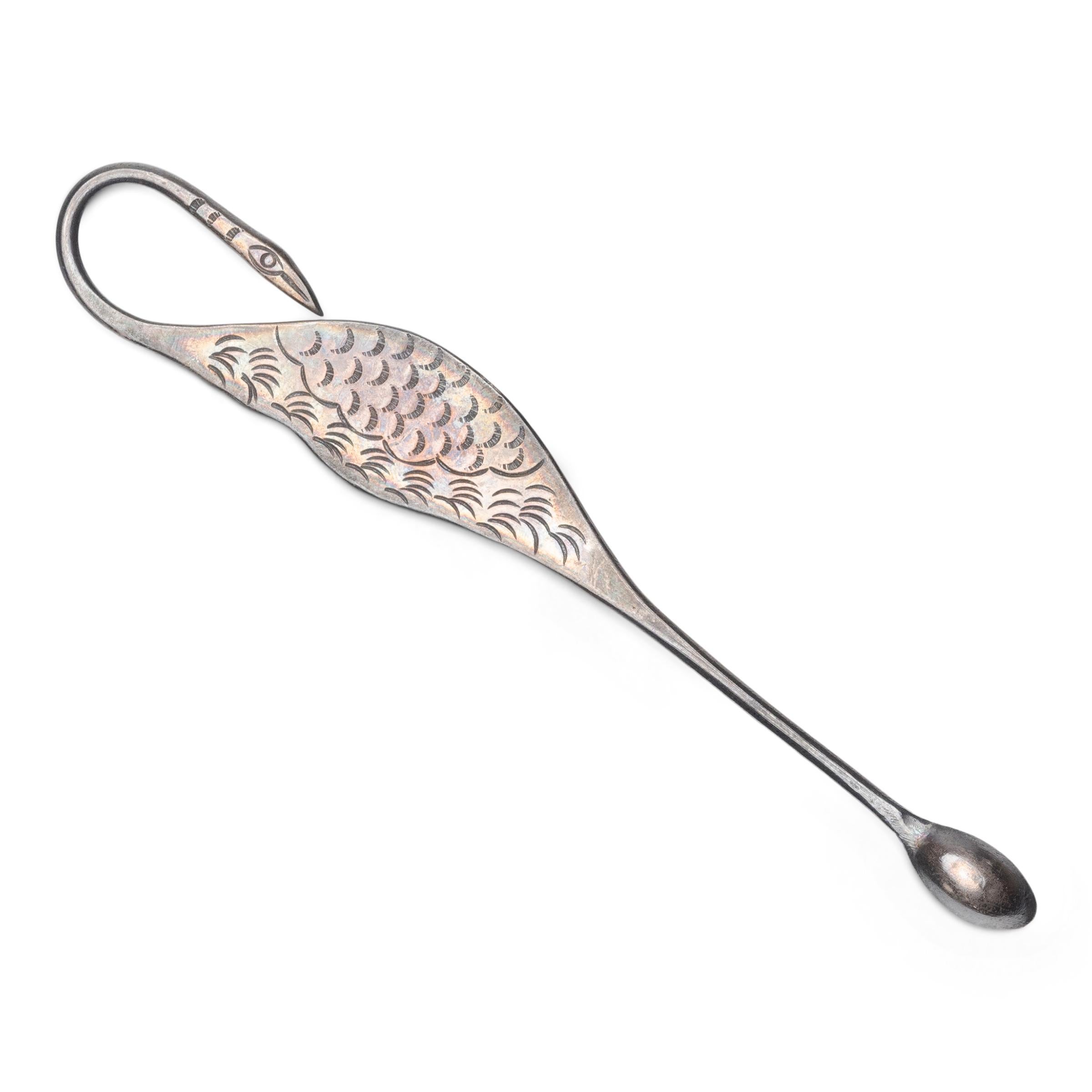 This petite silver spoon is actually an opium scraper, used to remove spent ash and debris from a pipe or pipe bowl. The elegant scraper is shaped as a crane, a symbol of longevity, and is etched with feathered plumage and stamped with a mark