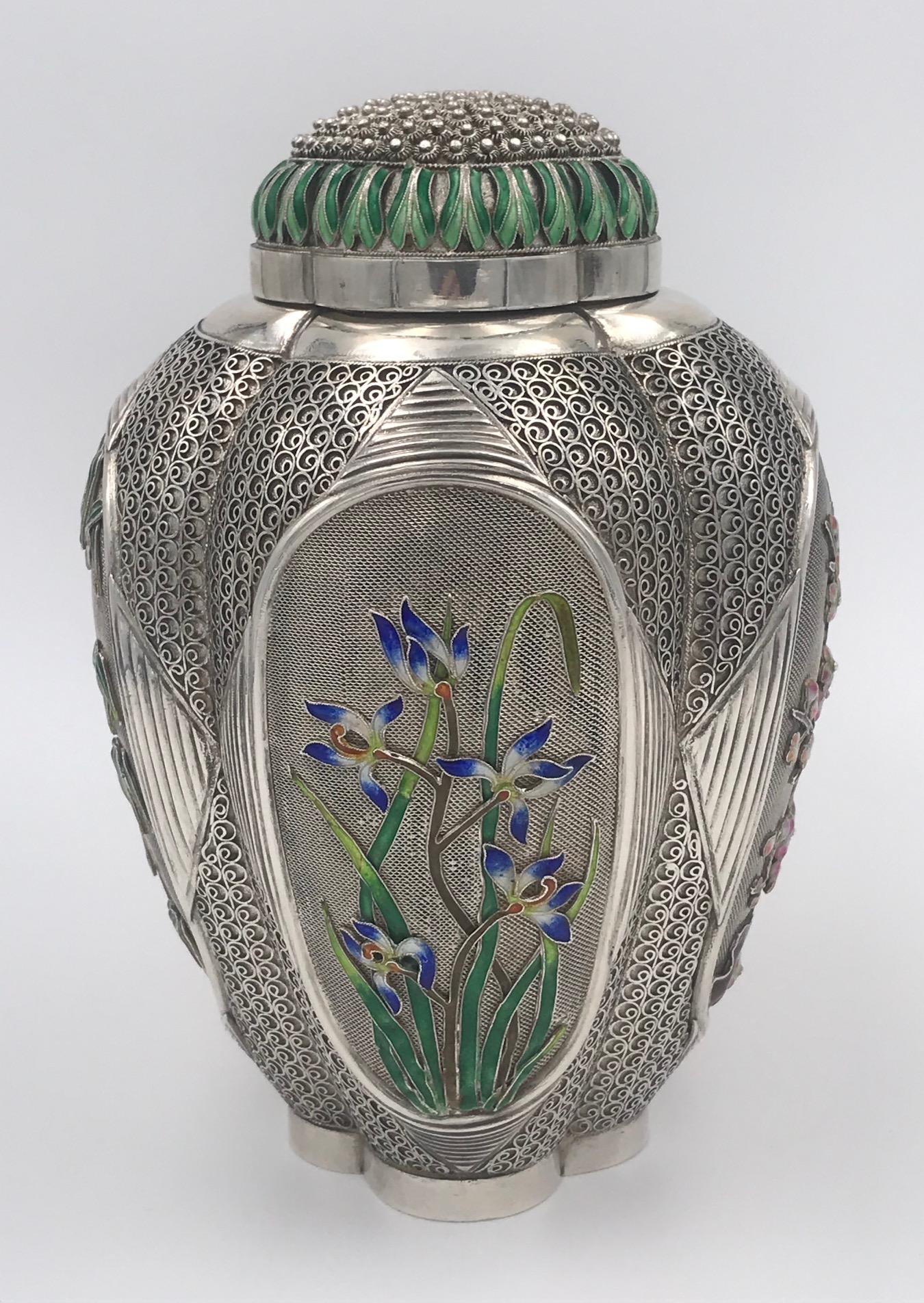 A beautifully decorated Chinese silver tea caddy with four enameled floral panels and further enamel to the pull-off lid.
The caddy is unmarked and dates from mid-20th century.