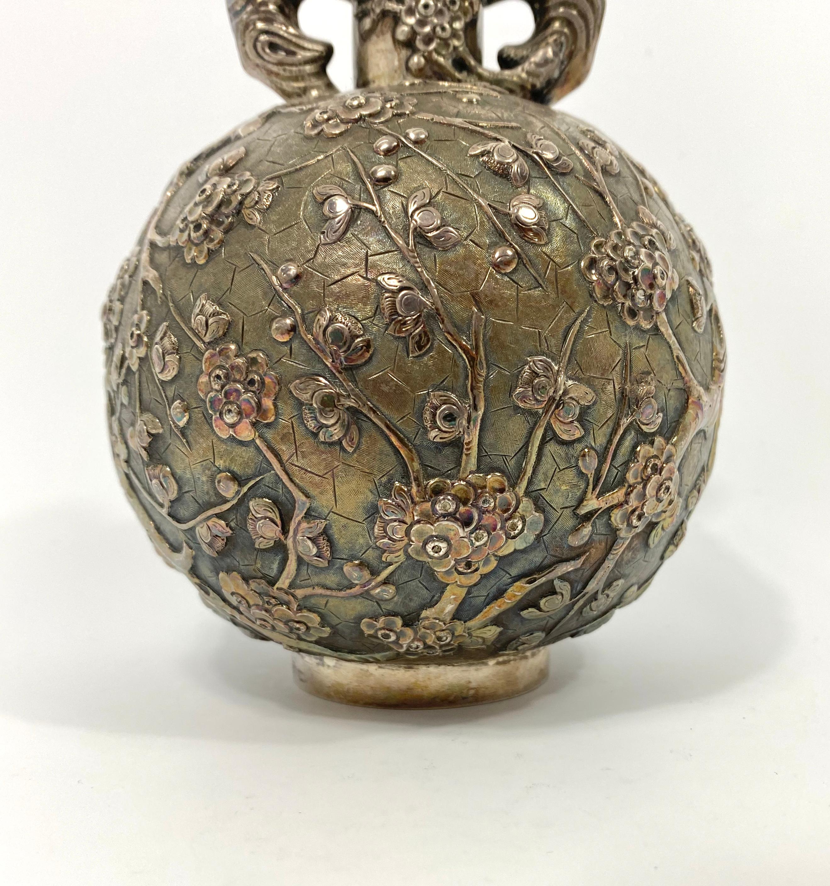 Chinese silver globular flask, Luen Wo, Shanghai, circa 1900. The heavy gauge silver flask, being cast and chased with flowering cherry blossom. The twin handles formed as large branches of the prunus tree, at the neck of the flask, all upon an