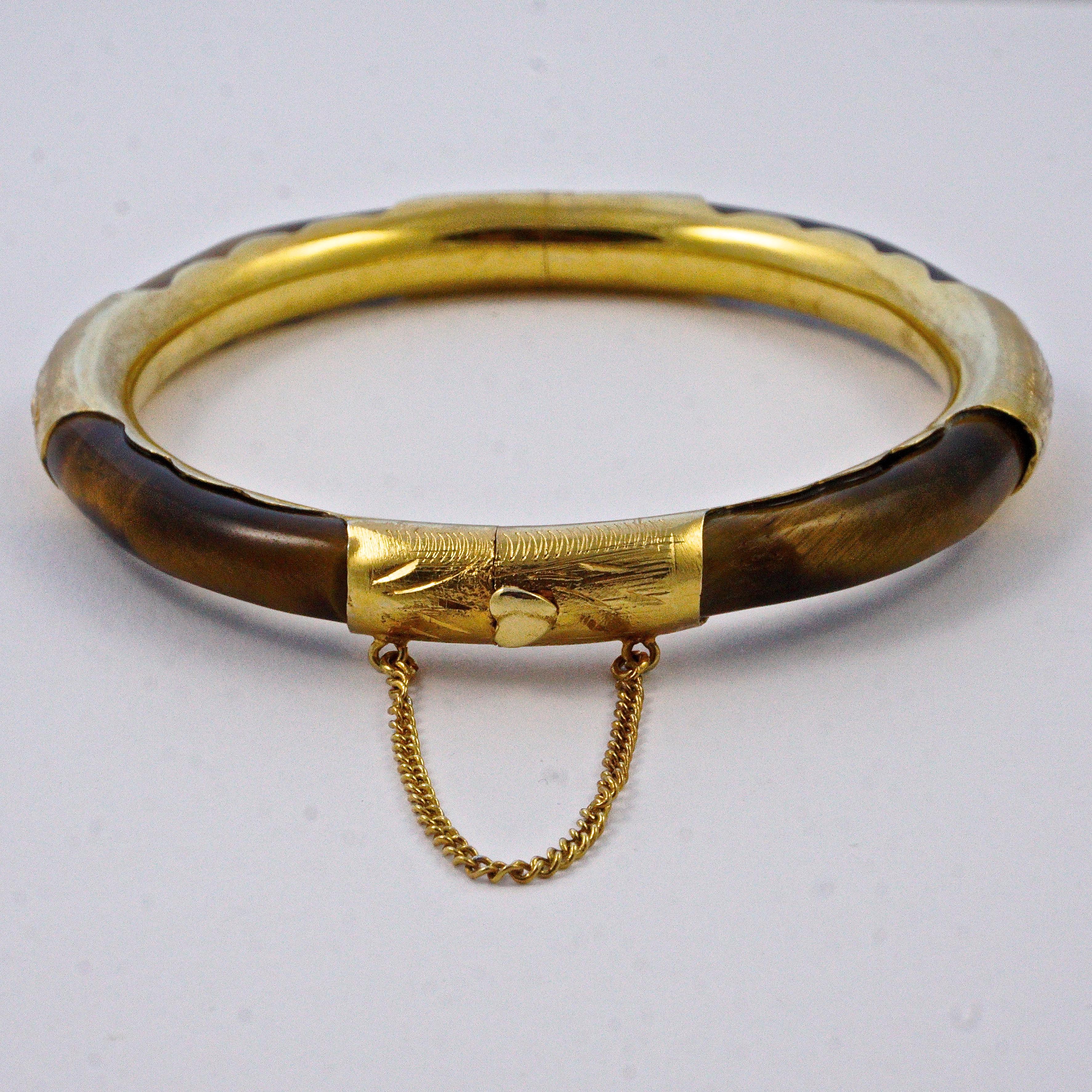 Chinese silver gilt bangle bracelet with a safety chain, featuring a circle of semi-precious tigers eye. Measuring inside diameter 5.9cm / 2.3 inches and width 7.5mm / .29 inch. The bracelet has a crack in the metal, please see last photo, this does