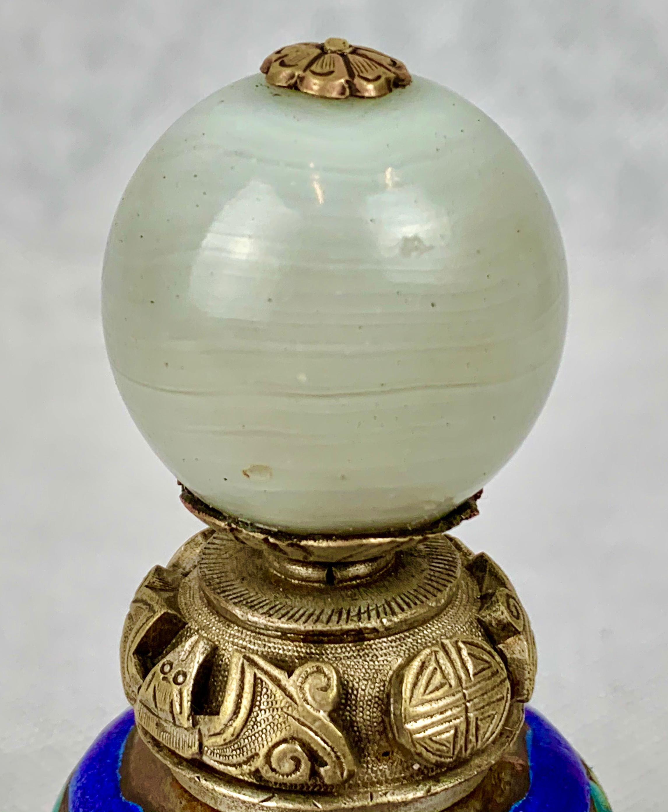 Chinese silver on copper enameled bell with peking glass finial and clapper. Some refer to these items as dinner bells, however, a great colorful collectable from old China. Originally a mandarin's hat button now repurposed as a bell.

Hand cleaned