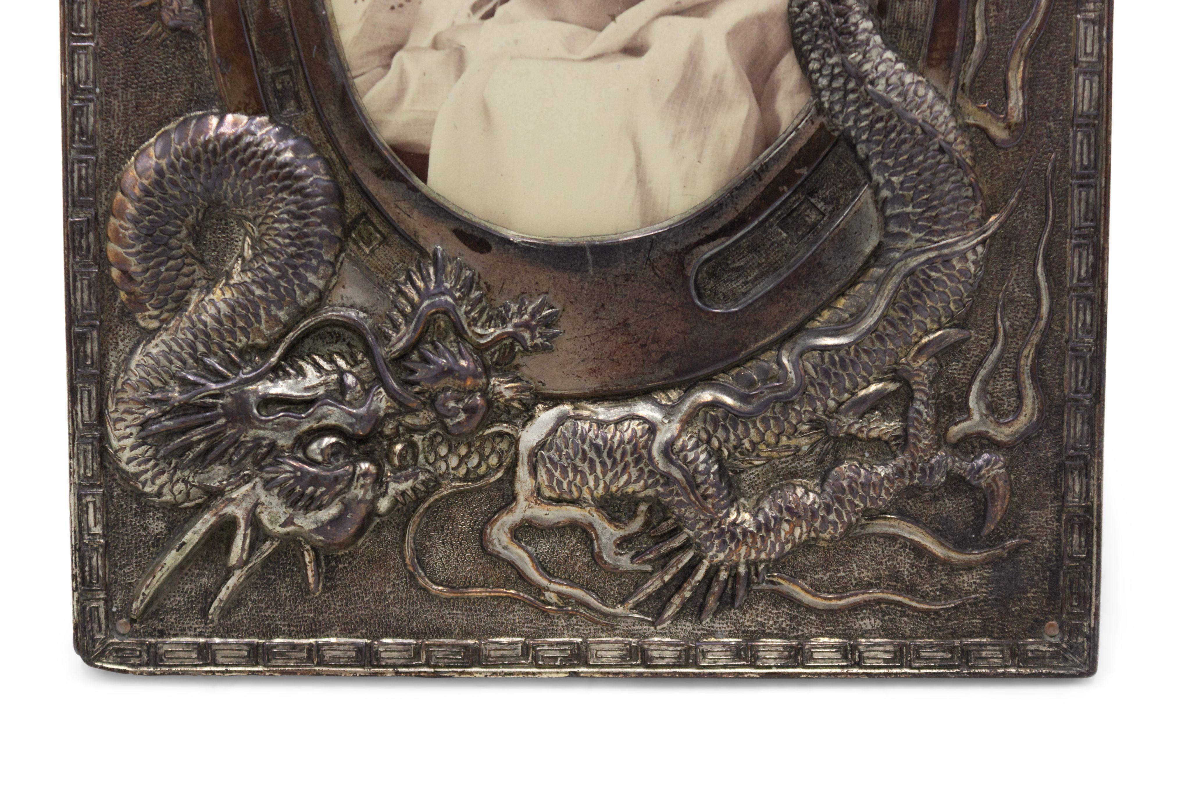 Asian Chinese-style silver plate rectangular easel picture frame with dragon and horse shoe embossed frame.