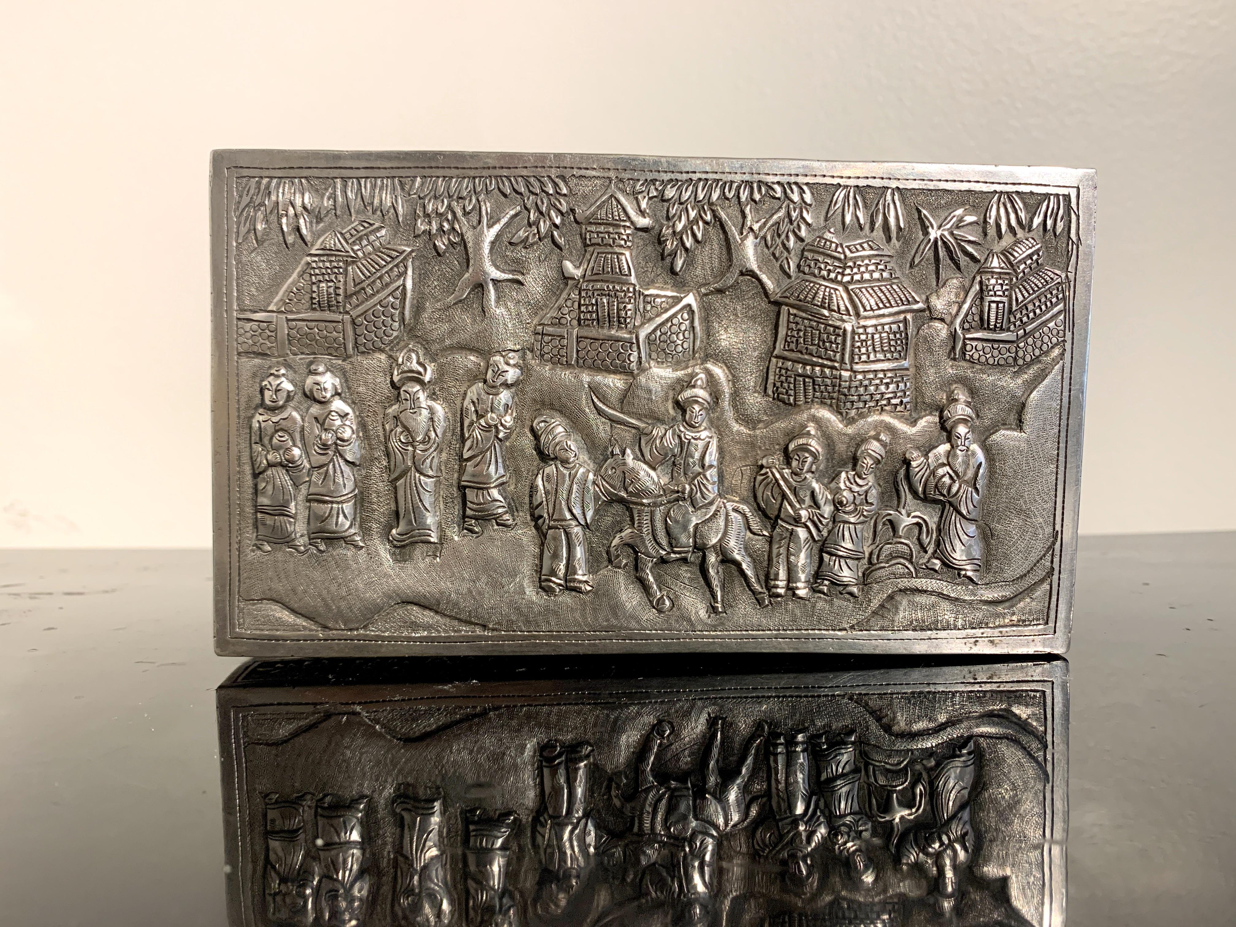 A fine late Qing or early Republic Period Chinese silver repoussé box featuring a scene possibly from the Romance of the Three Kingdoms, very early 20th century, China. 

The rectangular box with a hinged lid and decorated all over in high and low