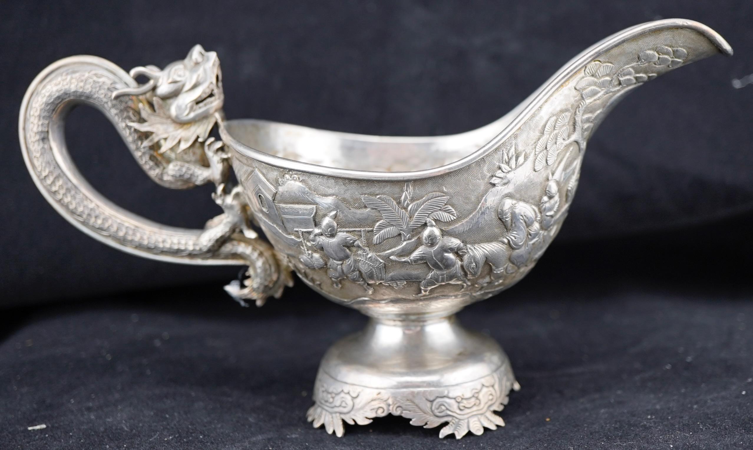 Chinese Export silver repousse sauce boat with dragon handles. Marked for Luen Wo.. Very fine decoration. 7 1/4