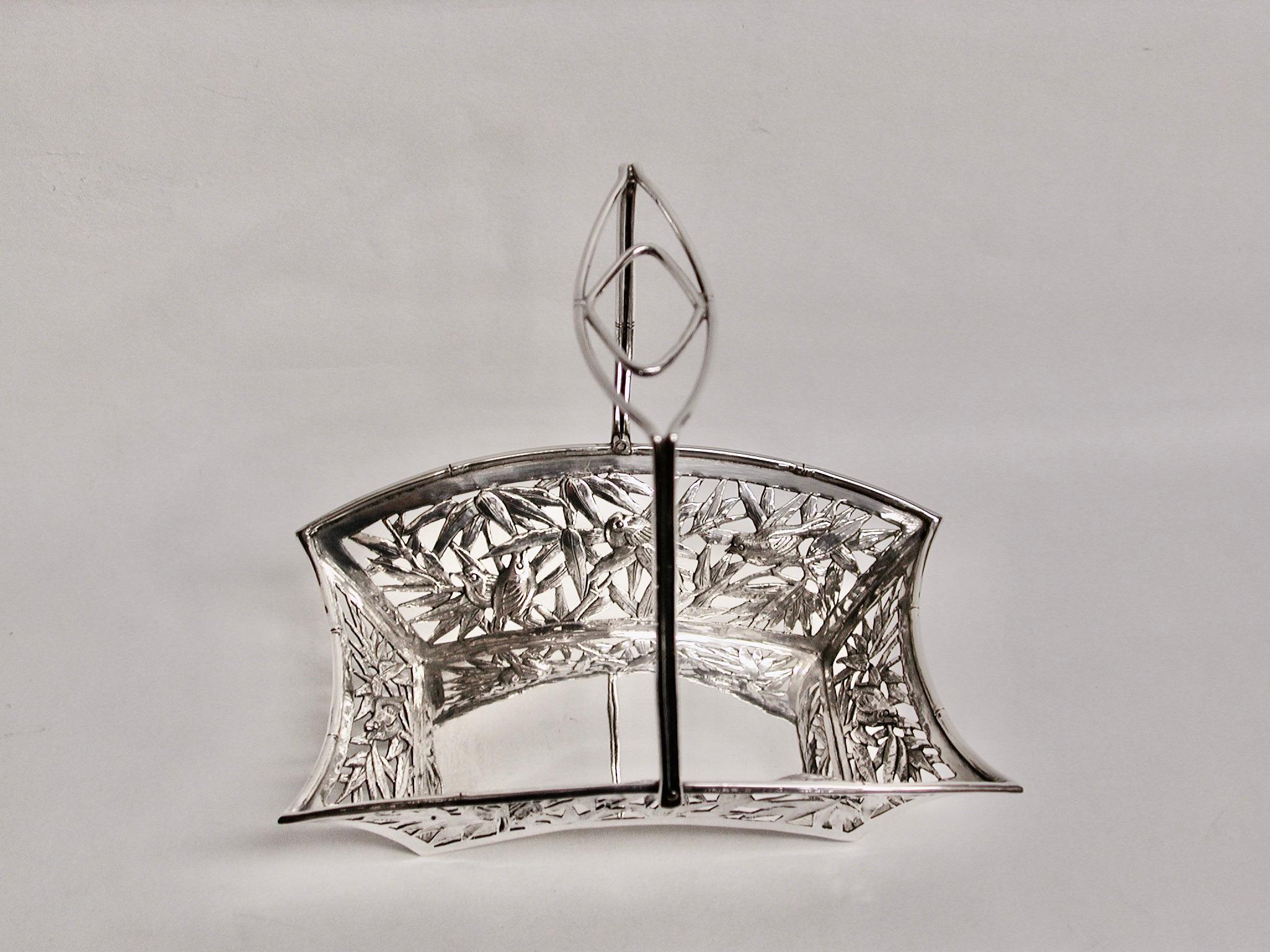 Chinese silver sweet basket with swing handle, Tuck Chang & Co, Shanghai, Circa 1900.
Lovely heavy quality piercing and embossing depicting several birds, bamboo and bamboo leaves.
Tuck Chang was a prolific Chinese silversmith in the last quarter