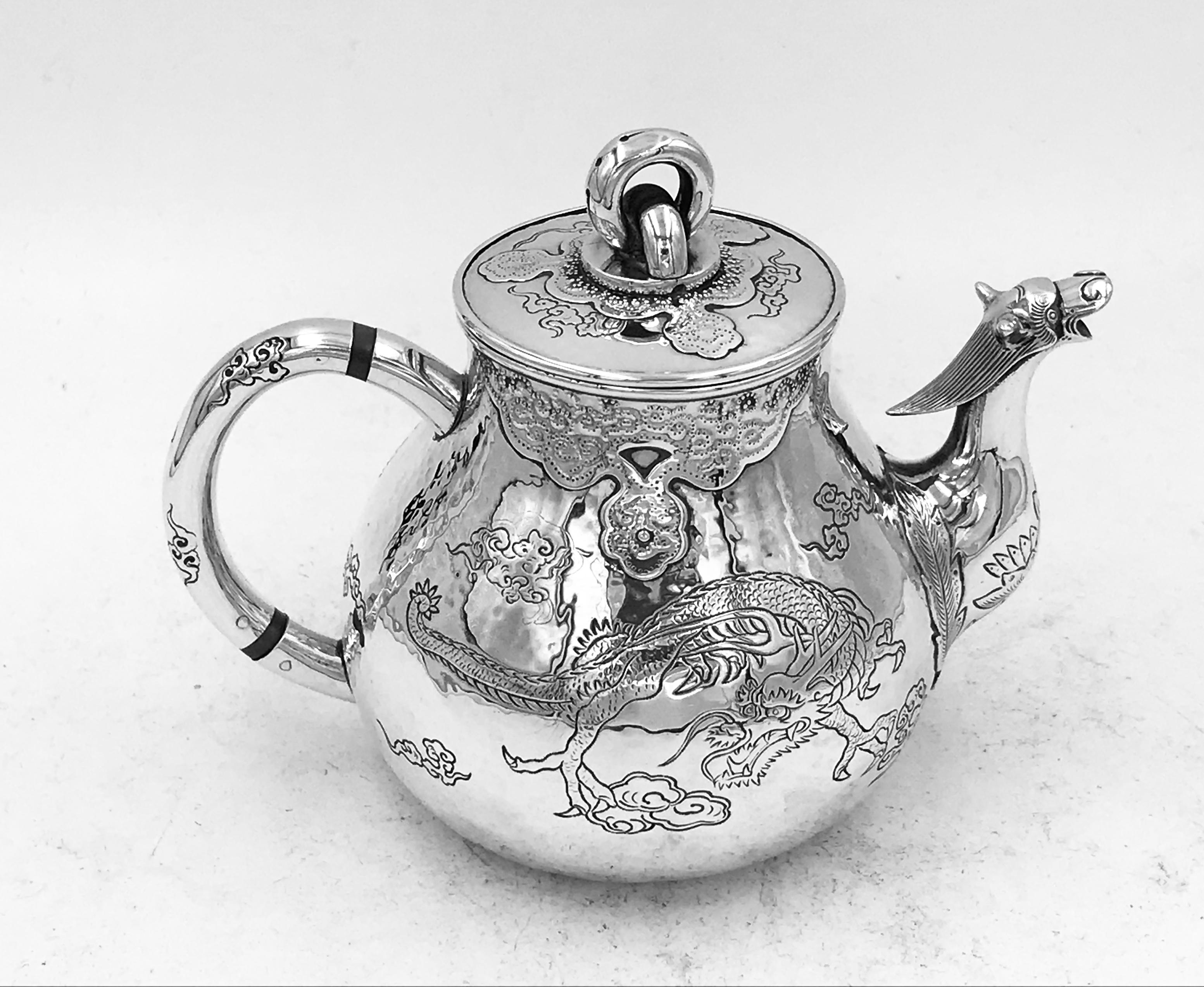 A small Chinese silver teapot made by Ring Sheng, from the Yuan Nan province, circa 1900. There is a dragon engraved to either side and a dragon-head spout.
The teapot weighs 132gms.