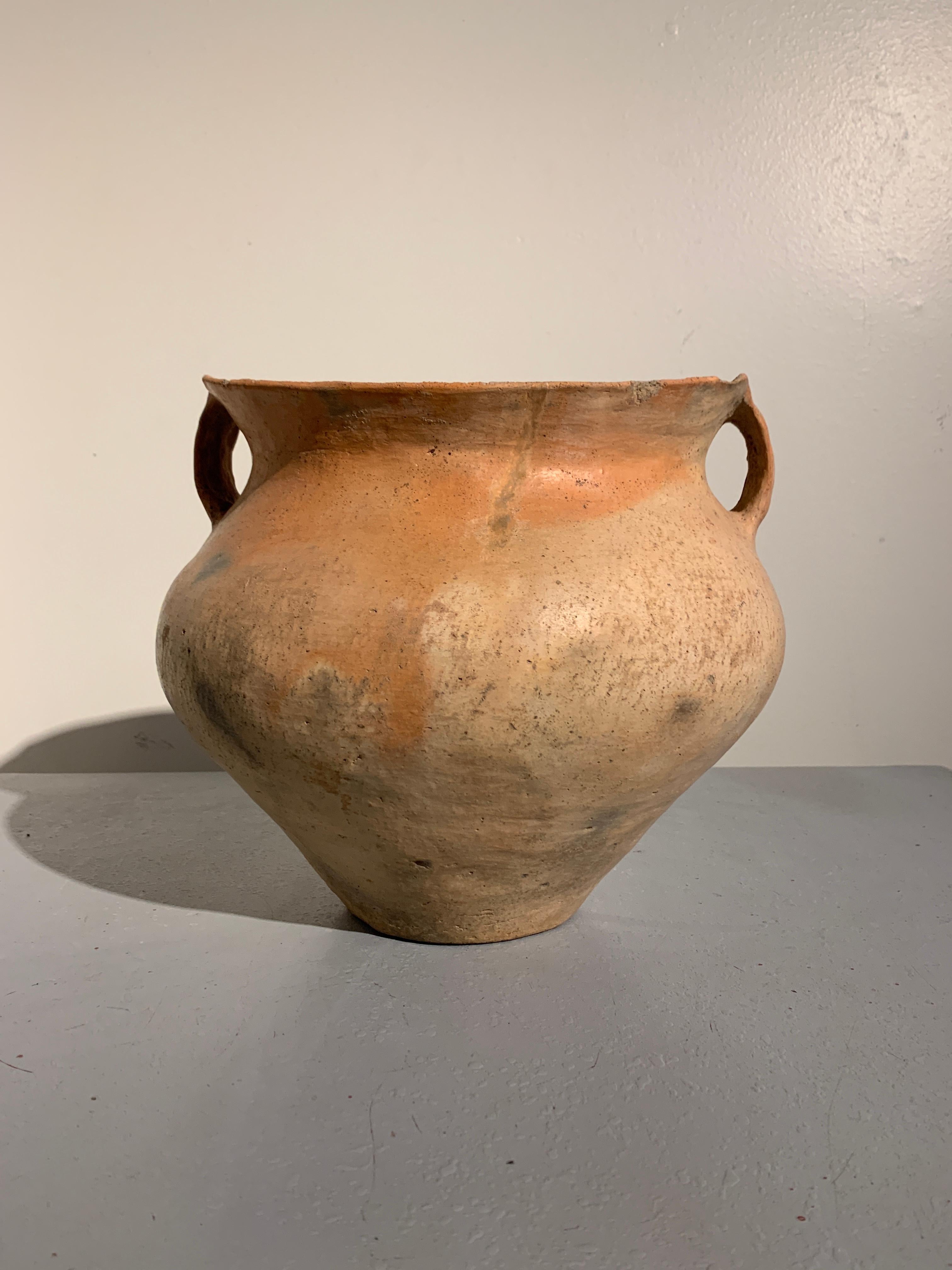 An alluring Chinese Neolithic Bronze Age pottery amphora vessel, Siwa Culture (14th-11th century BC), modern day Gansu Province, China.

The large pottery vessel of sensuous form, with a wide, flaring saddle shaped mouth and a pair of strap