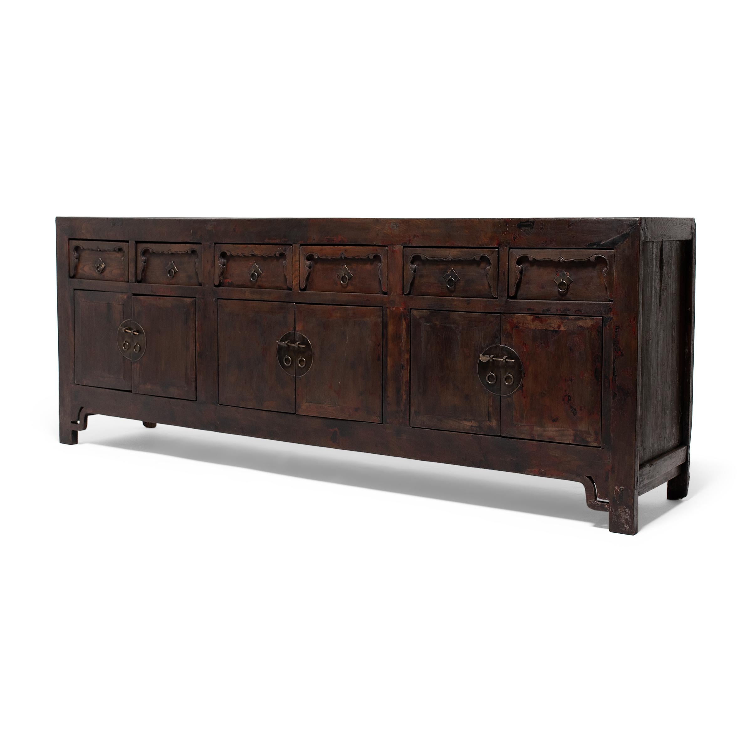 Created in the style of Mongolian storage coffers, this early 20th-century sideboard from Gansu province has a straightforward design and plenty of rustic appeal. Originally configured to open from the top, this chest was modified with front-facing