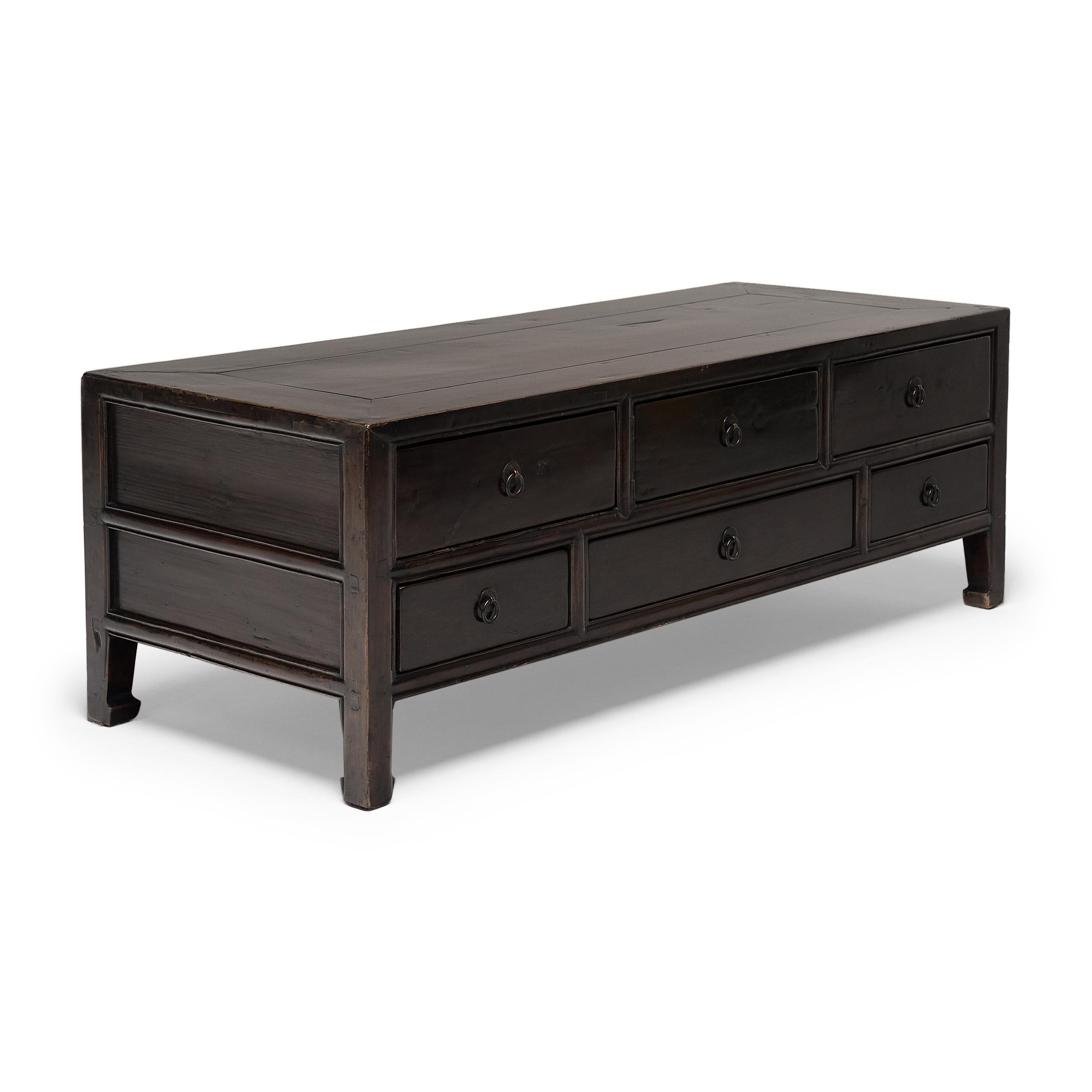 During winter in the colder provinces of China, life revolved around the kang, a heated brick platform that harnessed warmth from the kitchen fire. Used while seated atop the kang, low tables and cabinets such as this provided a convenient surface