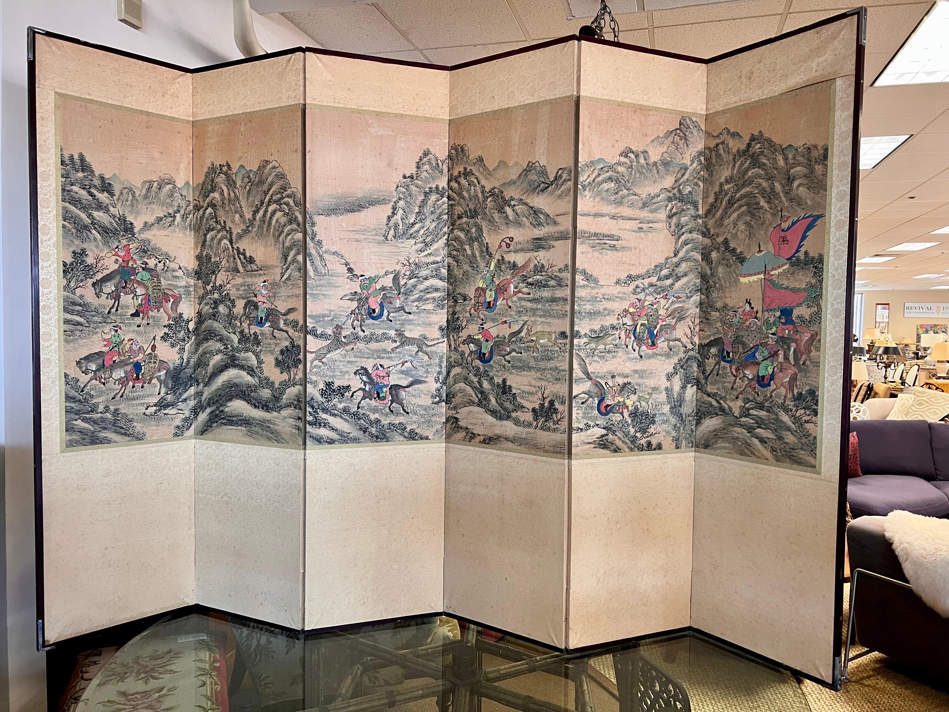 Exquisite six panel Chinese room divider folding screen features intricate handpainted landscape scenery with fighting scenes of warriors on horseback. A stunning visual masterpiece.