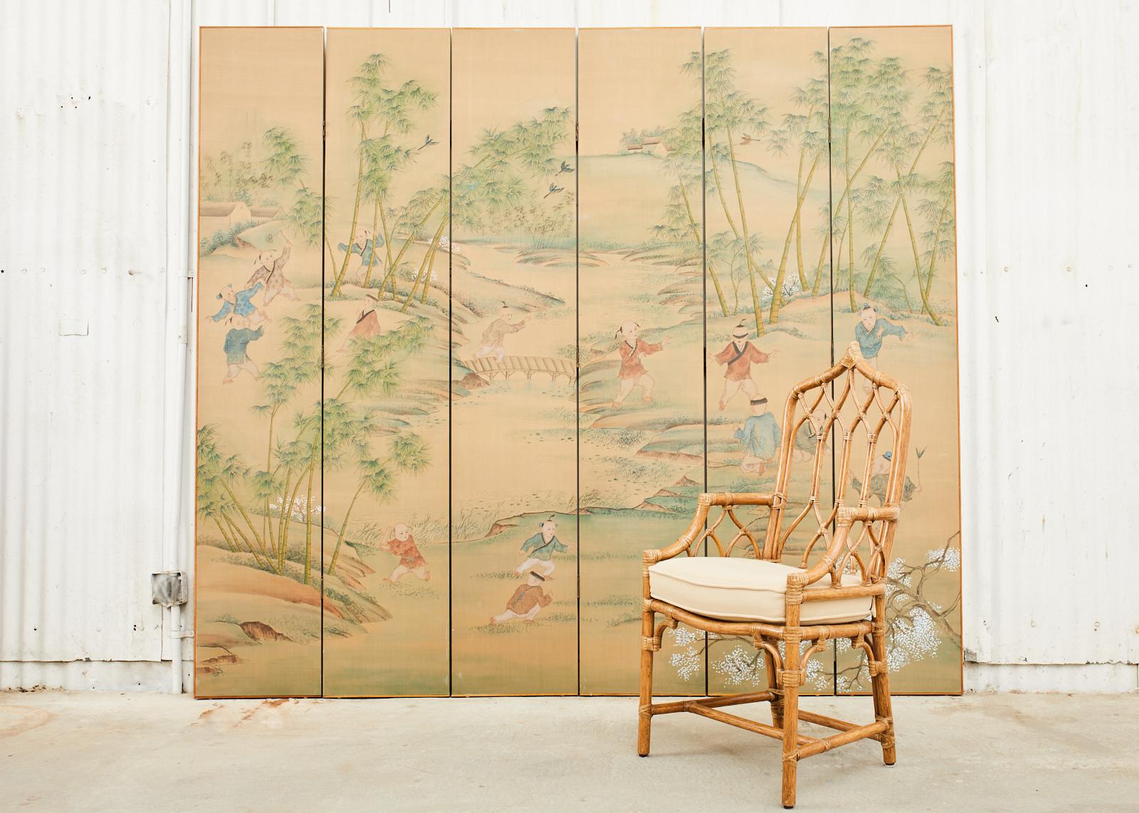Spectacular Chinese six-panel silk folding wallpaper screen crafted in the manner and style of Gracie's exotic landscapes by Maitland-Smith in Hong Kong. The screen depicts a lush spring landscape with young boys at play among bamboo groves.