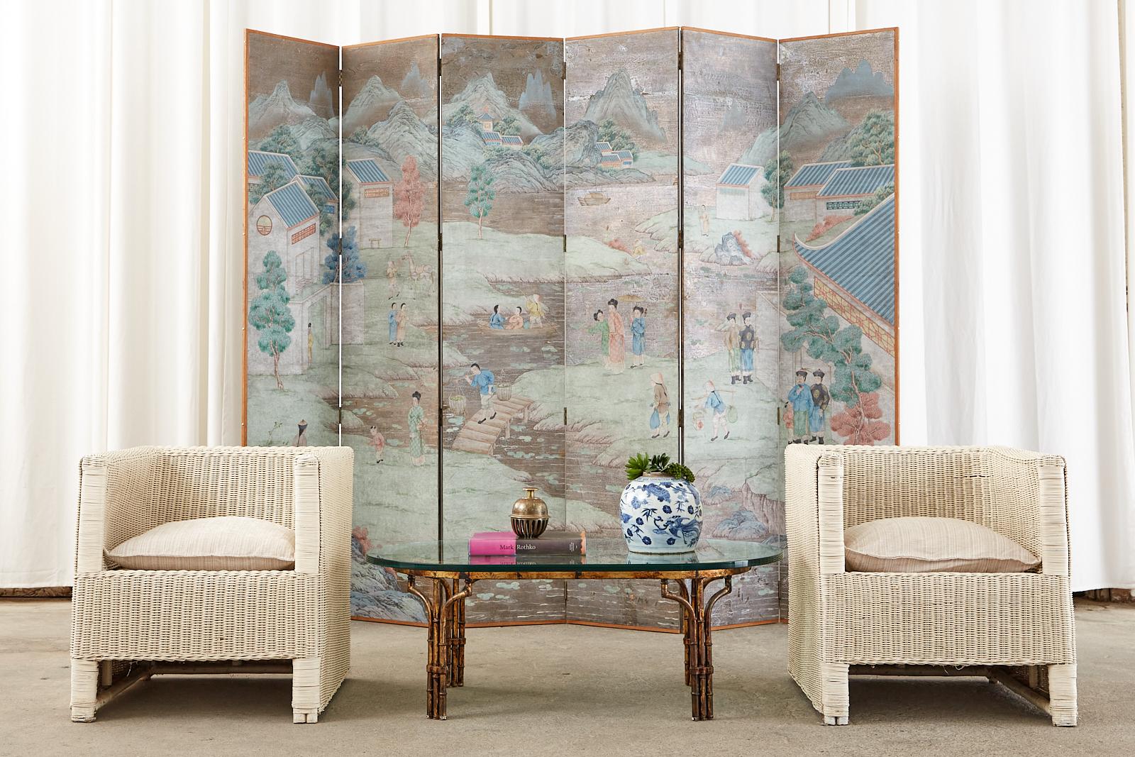 Exquisite Chinese export six-panel wallpaper screen featuring a hand-painted landscape with figures on a dramatic silver leaf ground. Made in the manner and style of Gracie's exotic landscape wallpaper paintings. Mounted on a six-panel screen with a