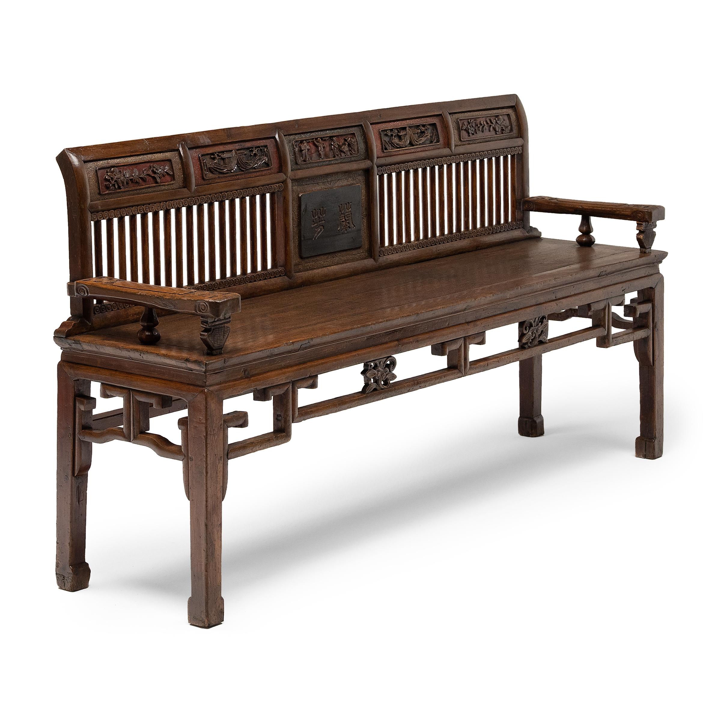 This charming bench from the early 20th century comfortably seats three and combines the proportions of Western furniture with the decorative opulence of Qing-dynasty designs. Crafted of elm with mortise-and-tenon joinery, the three-person bench