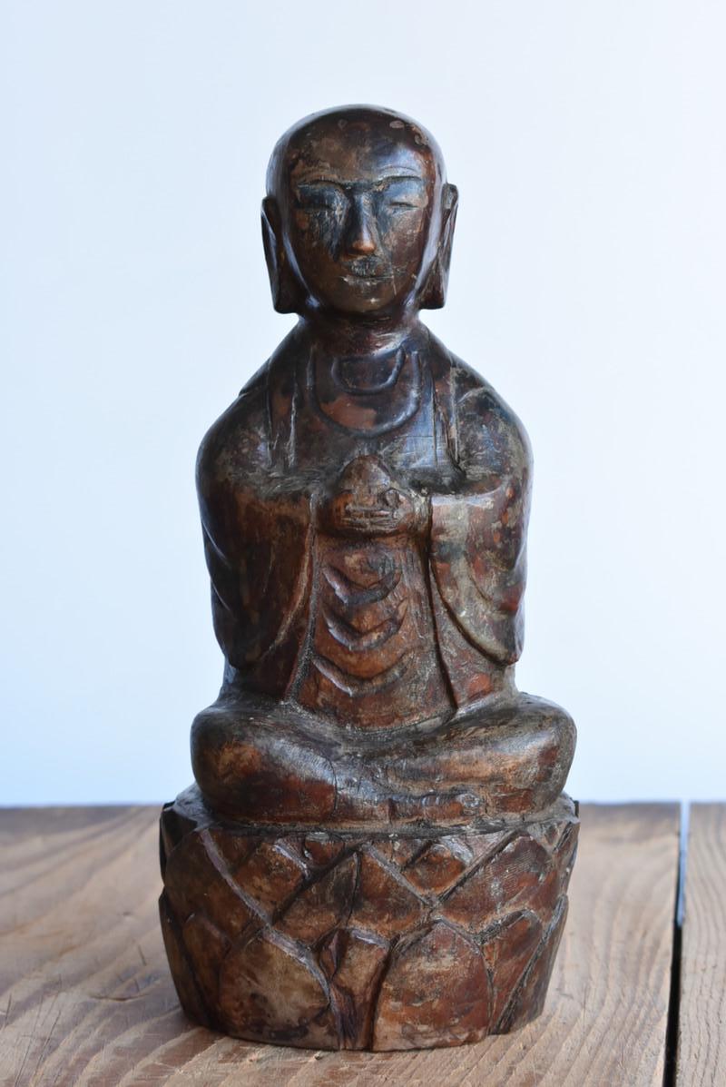 This is an old Chinese wooden carved Buddha statue.
I think it's about 1800to1900.

This Buddha statue is a Jizo Bodhisattva.
Jizo is one of the bodhisattvas in the world of Buddhism.
It is the one who saves the people of the world with an