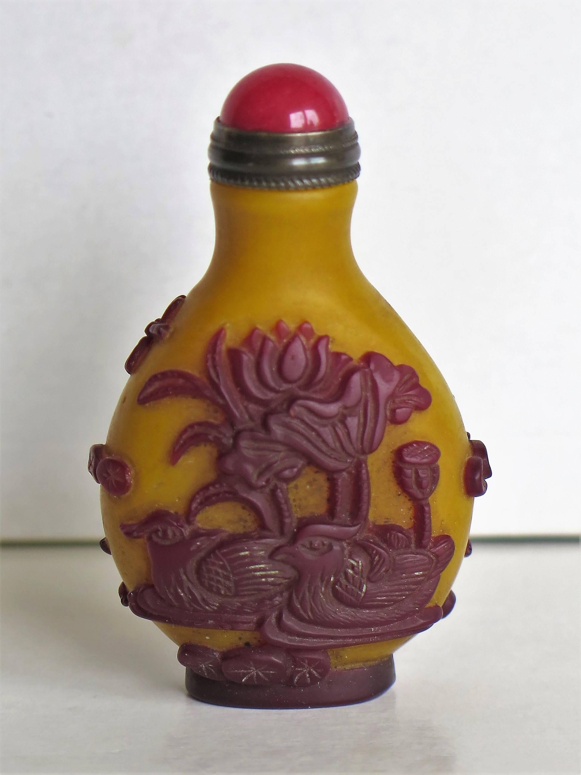 This is a very good Chinese cameo or overlay glass snuff bottle, which we date to the earlier part of the 20th century, circa 1920.

These overlay glass cameo snuff bottles are very decorative and sought after, particularly with the milky yellow
