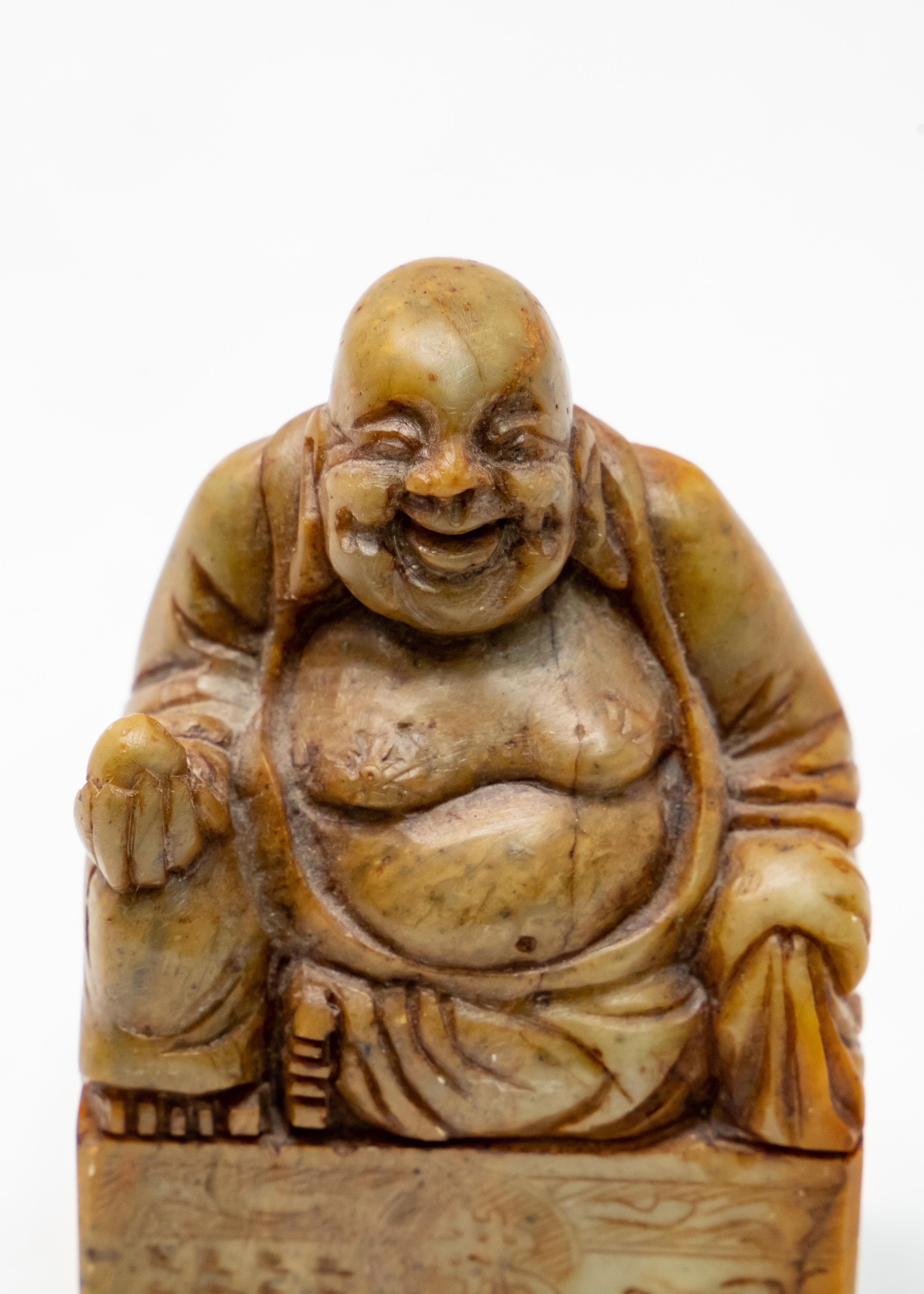 Offering this impressive soapstone chop seal. The top depicts a Shoushan Buddha holding an egg shaped stone in one hand. He sits atop a rectangular base with Chinese symbols engraved in the stone.

History of the Chinese chop seal. Chop seals have