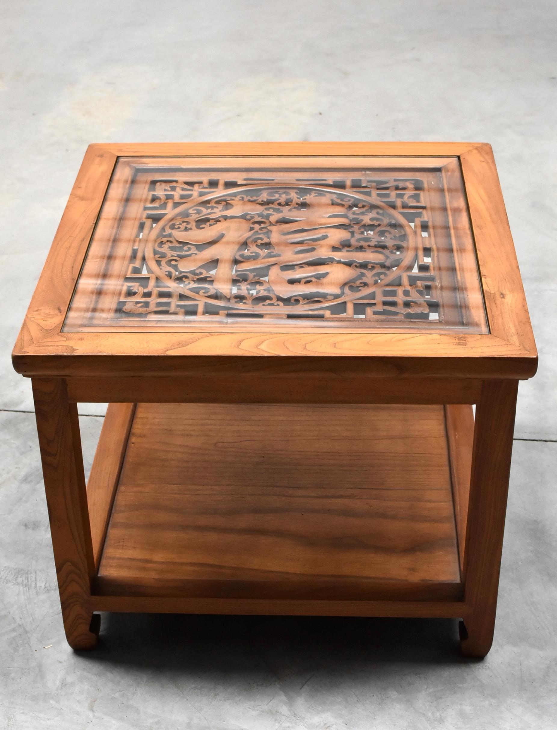 A beautiful natural finish square table made of solid elmwood. The tabletop is inset with a piece of hand-carved screen featuring the character 