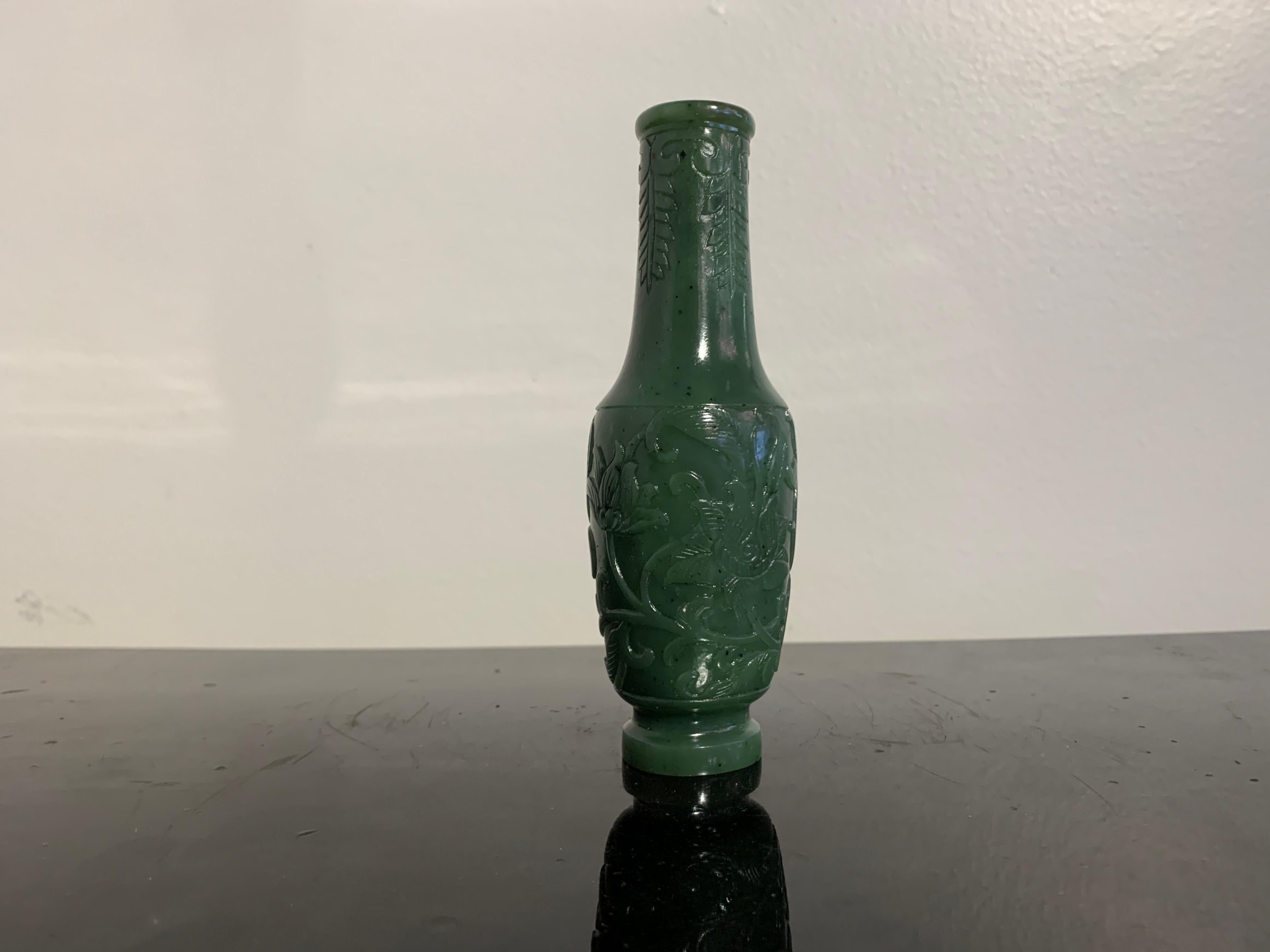 A fine and well carved Chinese spinach jade incense tool vase, Qing Dynasty, Qianlong or Jiaqing Period, 18th/19th century, China.

The small jade vase of medium dark green hue with black flecks throughout, commonly known as spinach jade. The jade